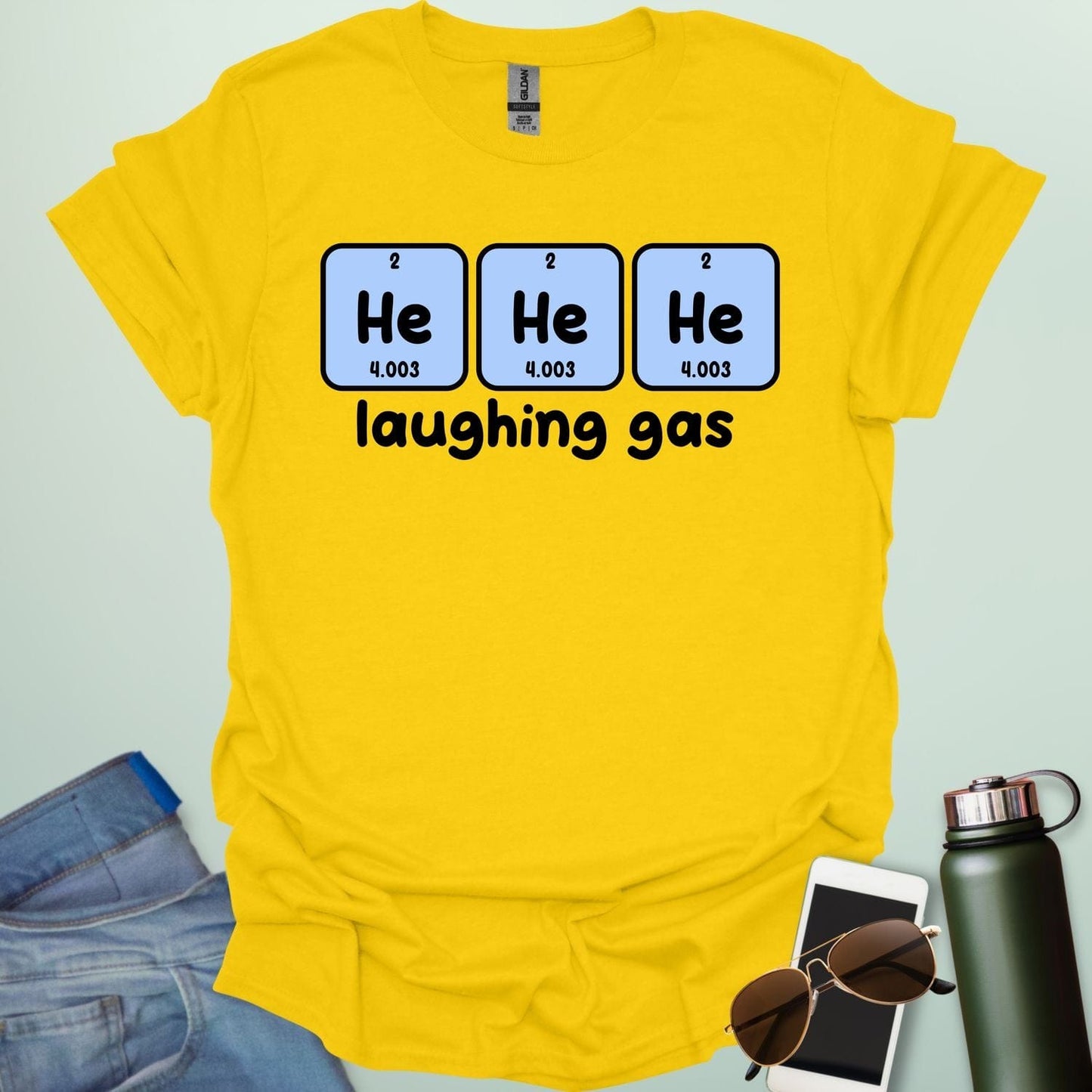 Three periodic table element boxes showing 'He' for Helium, with the text 'laughing gas' below.