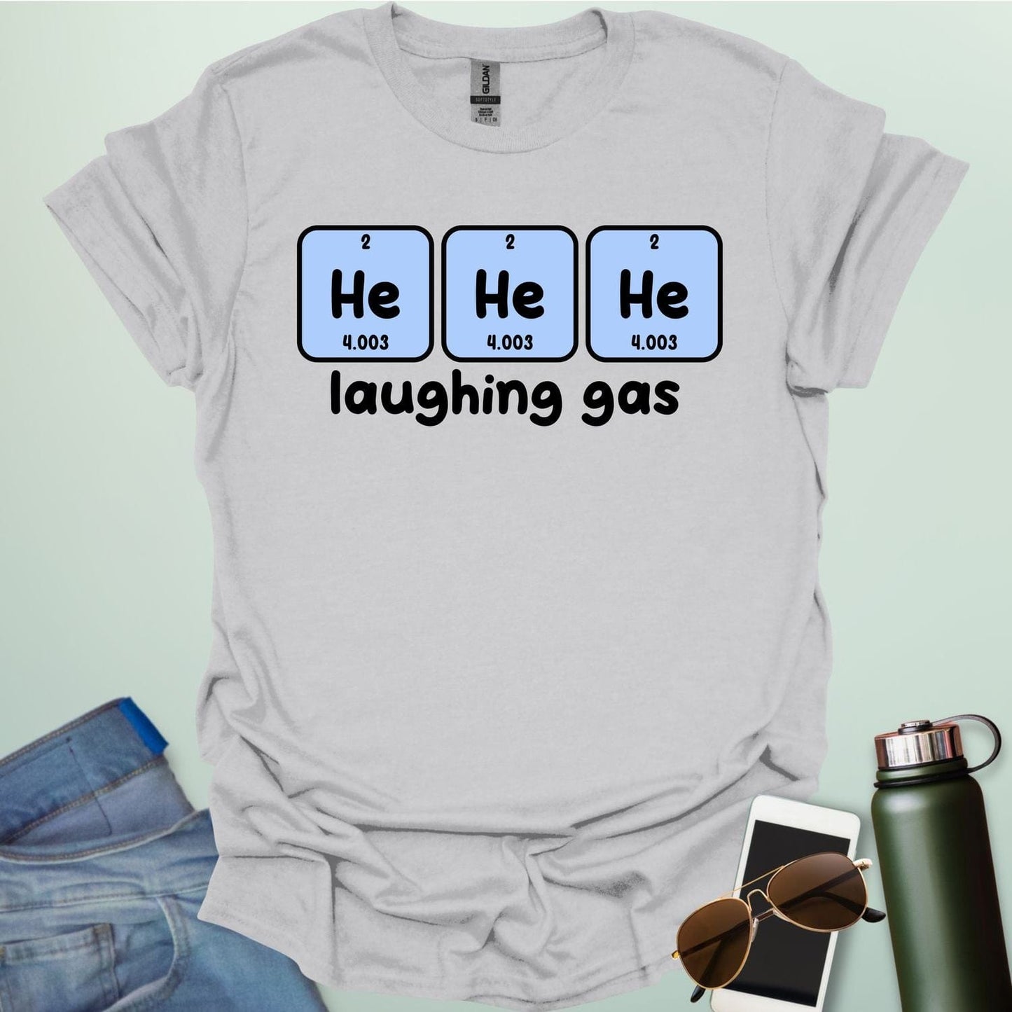 Three periodic table element boxes showing 'He' for Helium, with the text 'laughing gas' below.
