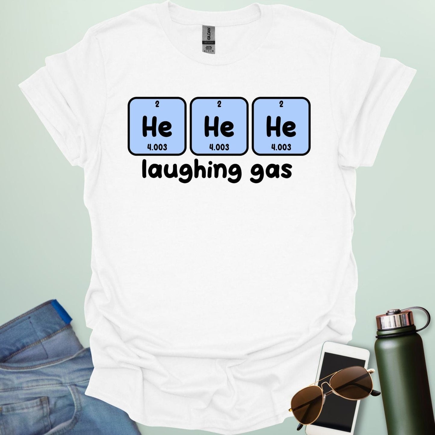 Three periodic table element boxes showing 'He' for Helium, with the text 'laughing gas' below