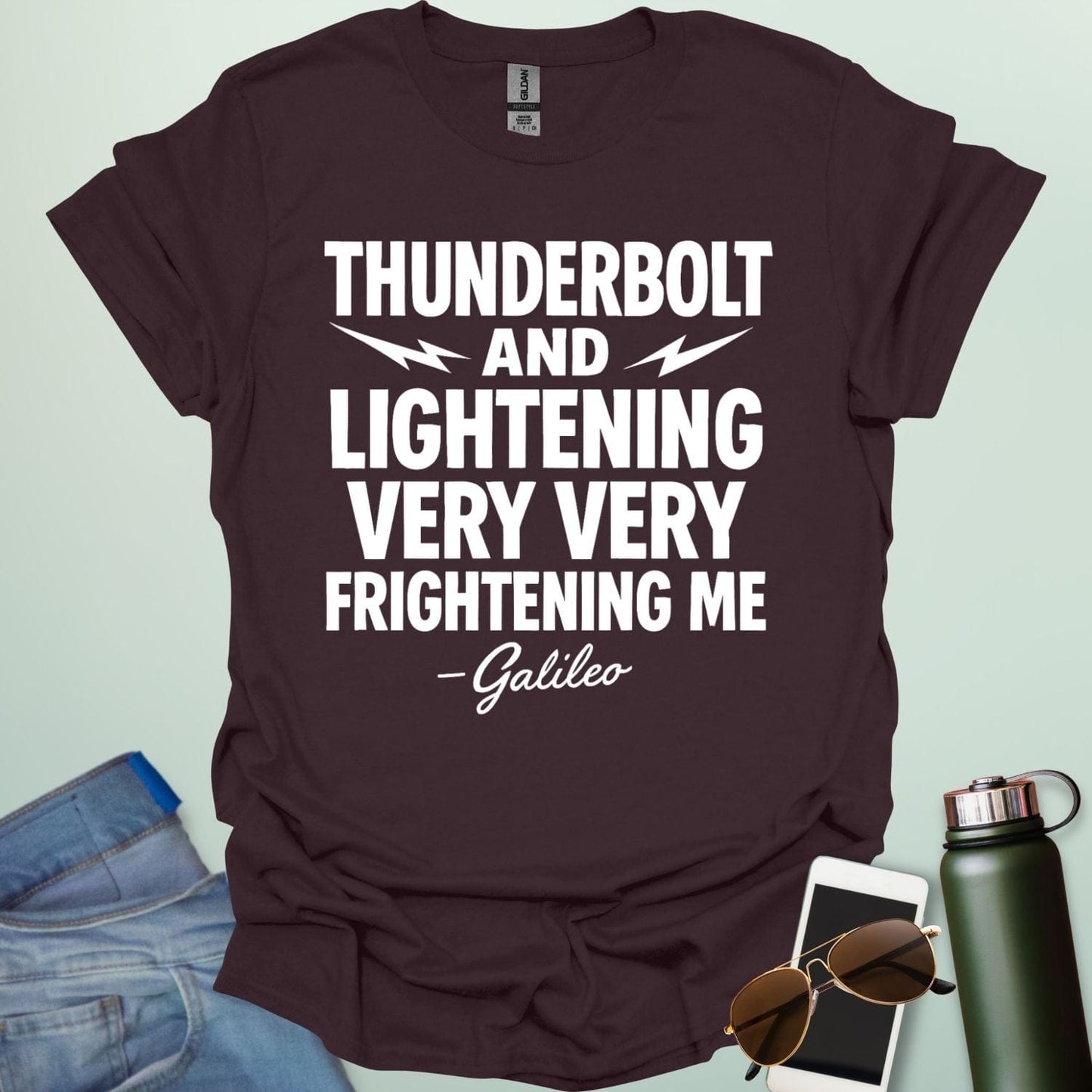 A dark chocolate t-shirt with the phrase 'THUNDERBOLT AND LIGHTENING VERY VERY FRIGHTENING ME' with lightning bolts, and '- Galileo' in script below.