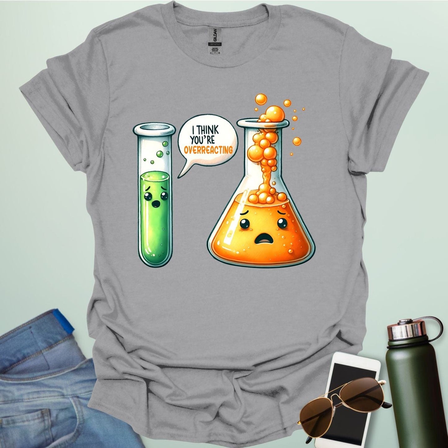 Sport Grey t-shirt with a graphic of two test tubes and a beaker on a light gray background. The test tube says, "I THINK YOU'RE OVERREACTING"