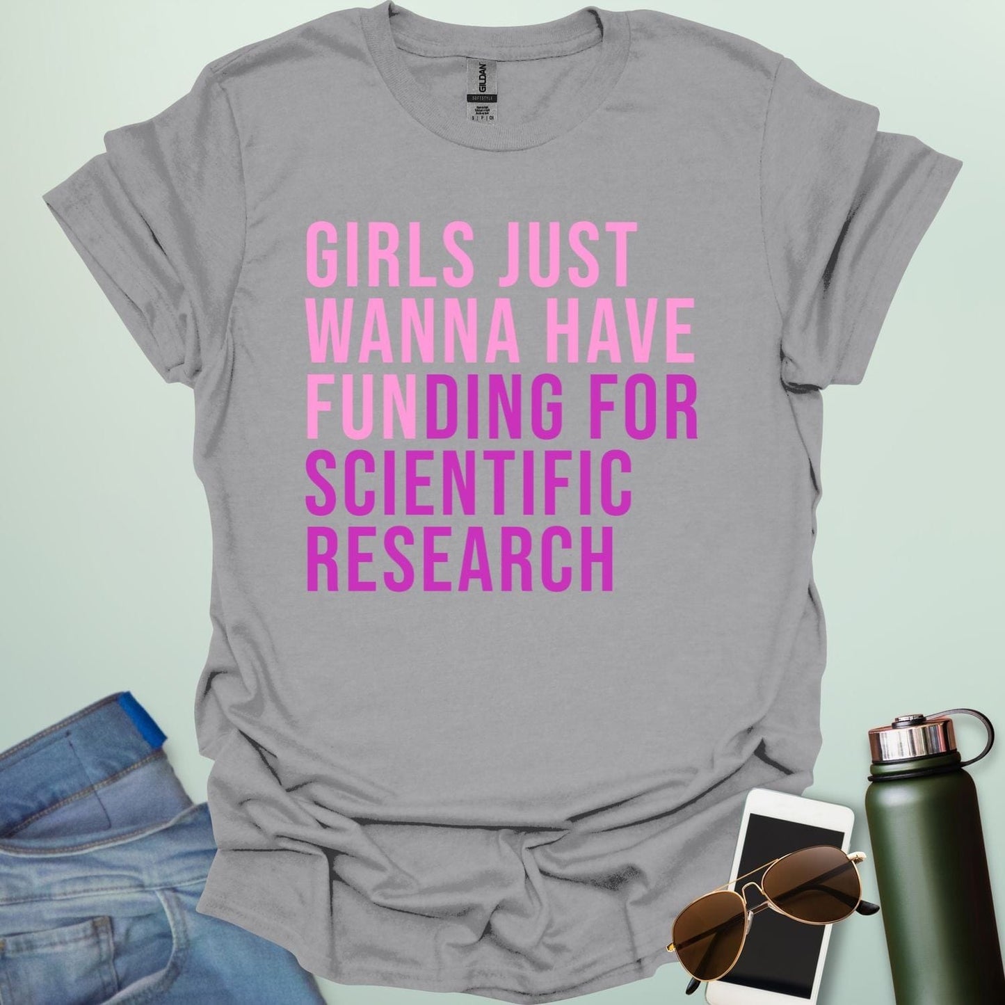 A sport grey t-shirt with the phrase 'Girls just wanna have funding for scientific research' in a bold, pink sans-serif font.