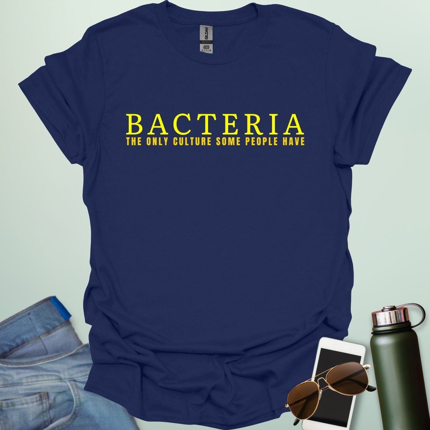 A navy blue t-shirt with the text 'BACTERIA THE ONLY CULTURE SOME PEOPLE HAVE' in yellow, bold font.