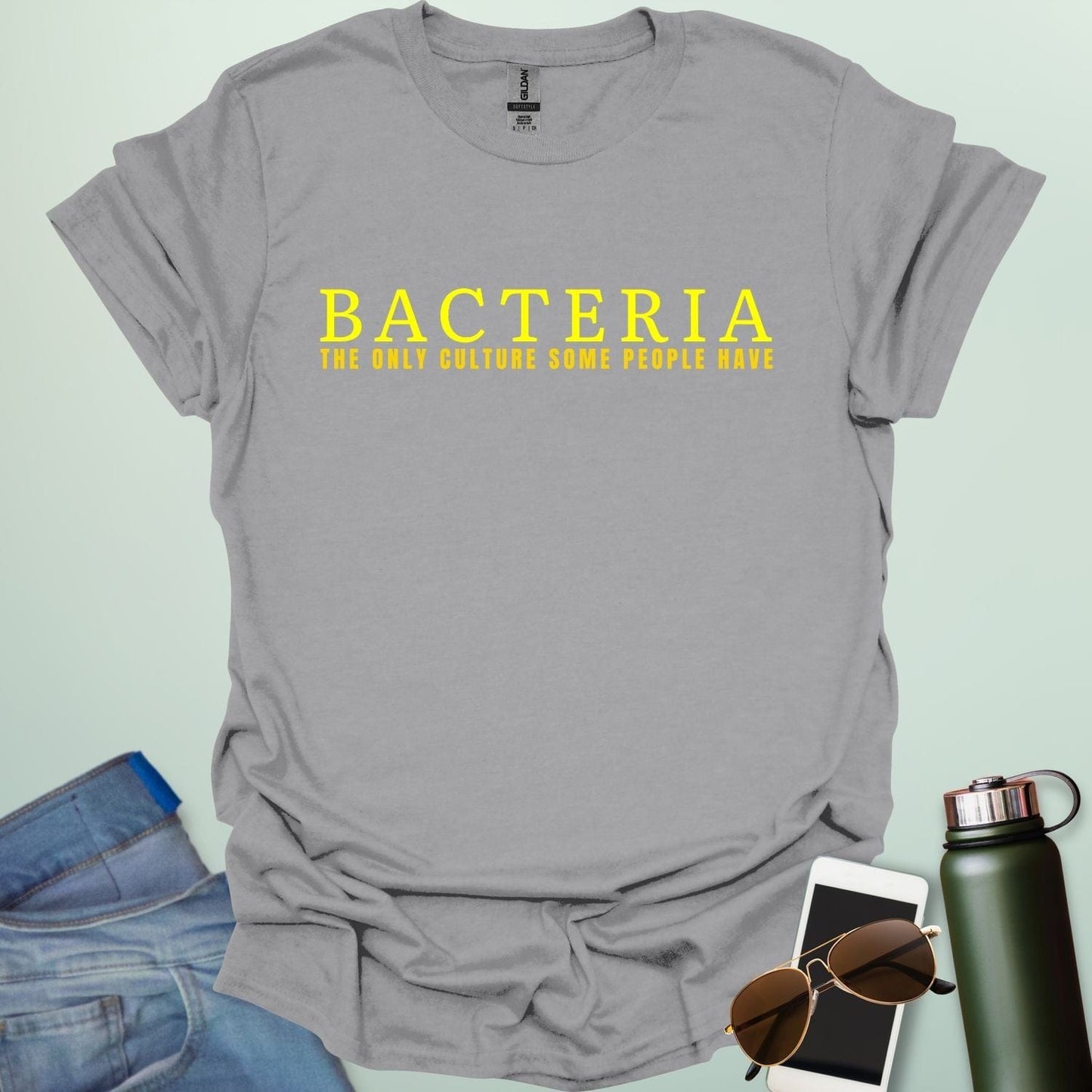 A sport grey t-shirt with the text 'BACTERIA THE ONLY CULTURE SOME PEOPLE HAVE' in yellow, bold font.