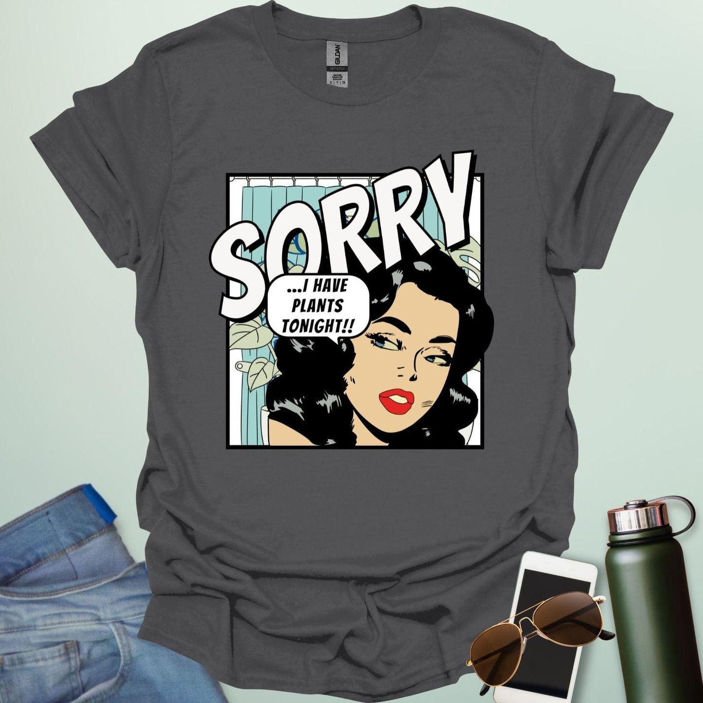 A charcoal grey t-shirt with a retro comic-book style illustration of a woman and the text 'SORRY ...I HAVE PLANTS TONIGHT!!'