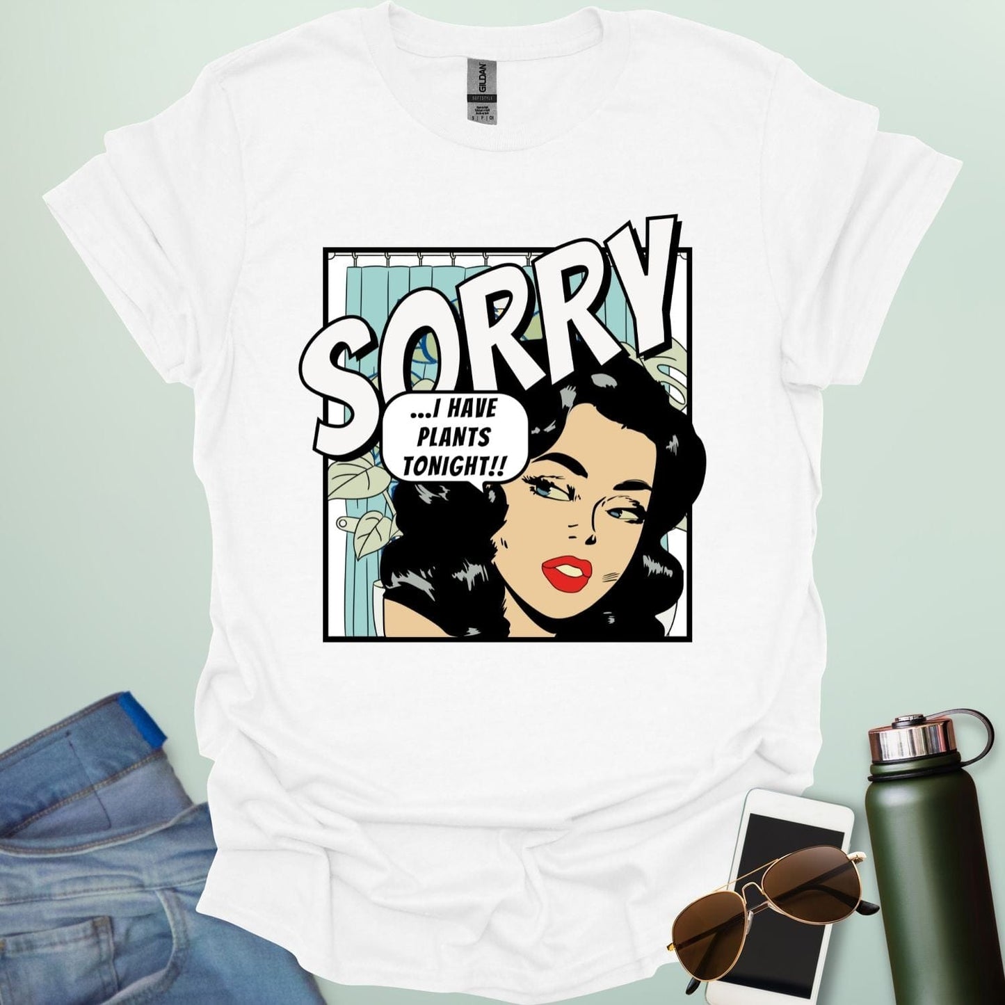 A white t-shirt with a retro comic-book style illustration of a woman and the text 'SORRY ...I HAVE PLANTS TONIGHT!!'