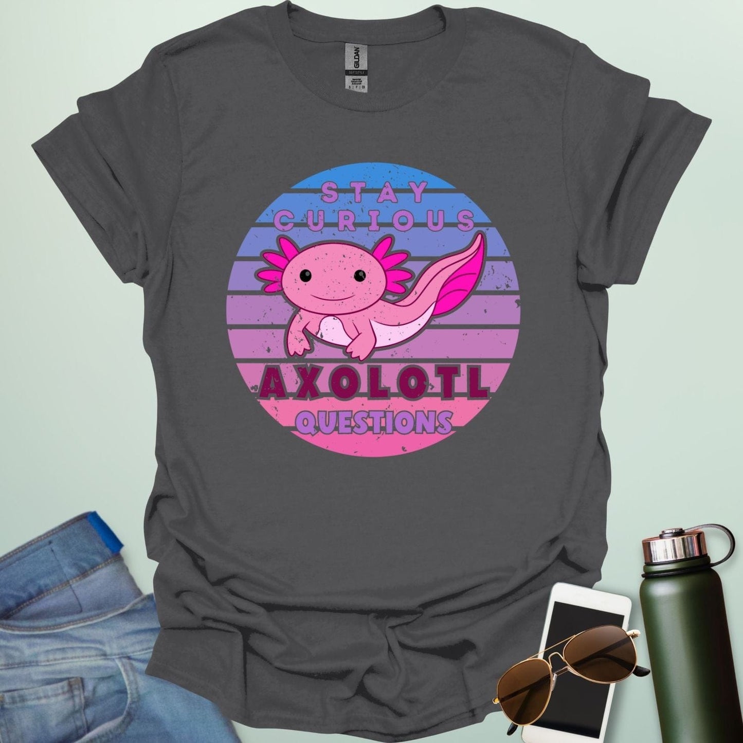 A charcoal grey t-shirt with a cute axolotl in a circular design and the text 'Stay Curious Axolotl Questions.'