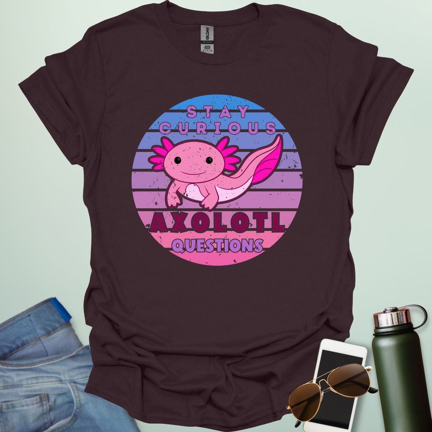 A dark chocolate t-shirt with a cute axolotl in a circular design and the text 'Stay Curious Axolotl Questions.'