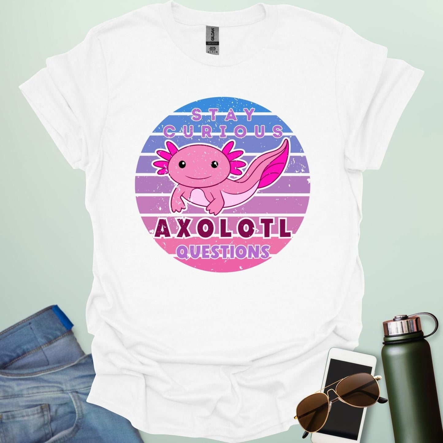 A white t-shirt with a cute axolotl in a circular design and the text 'Stay Curious Axolotl Questions.'