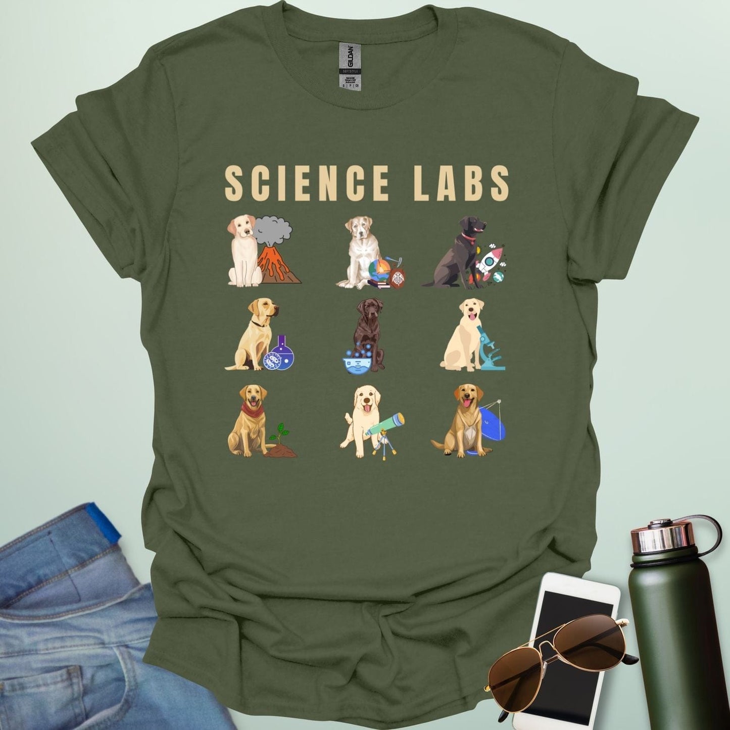 A military green t-shirt with the text 'SCIENCE LABS' and a grid of nine illustrations of Labrador Retrievers in various science-themed scenarios.