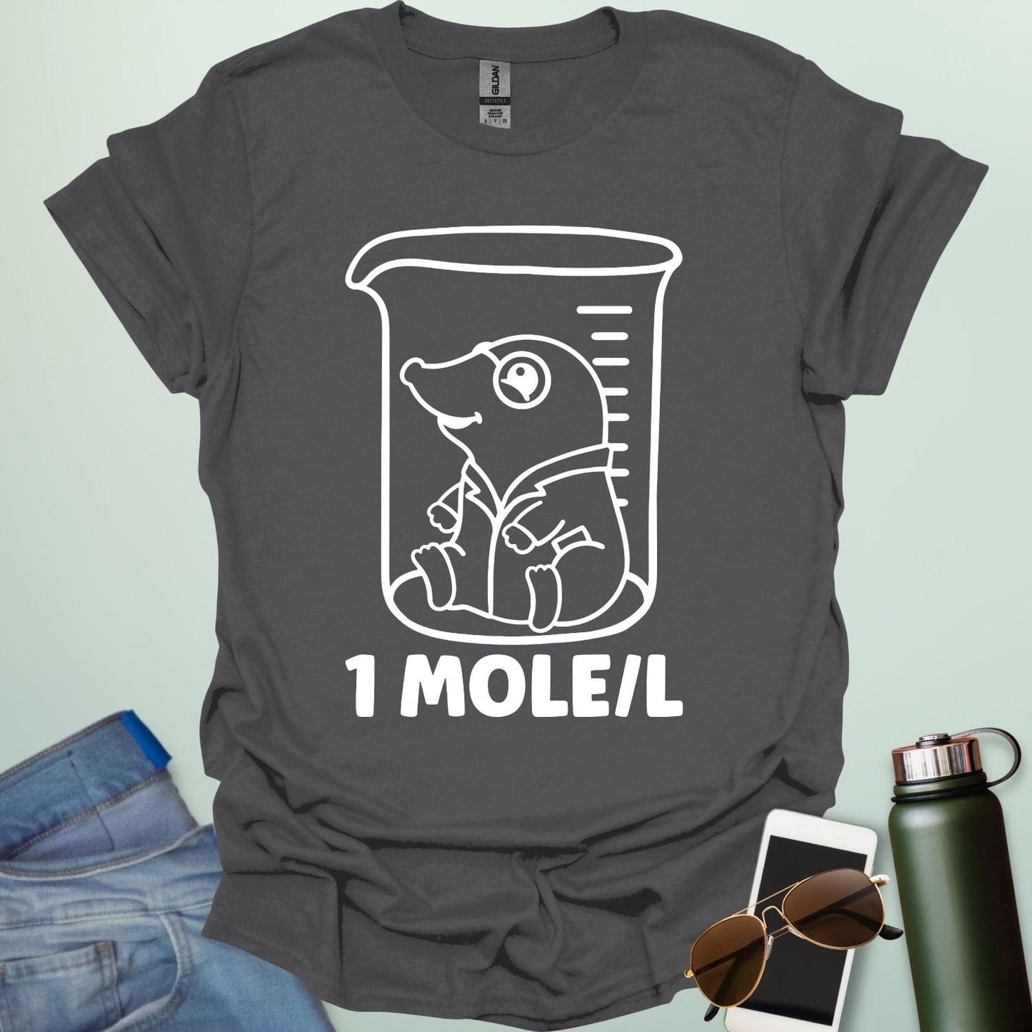 A funny chemistry t-shirt featuring a cartoon mole inside a science beaker. The design includes the text '1 MOLE/L,' a clever pun for chemists and science students.