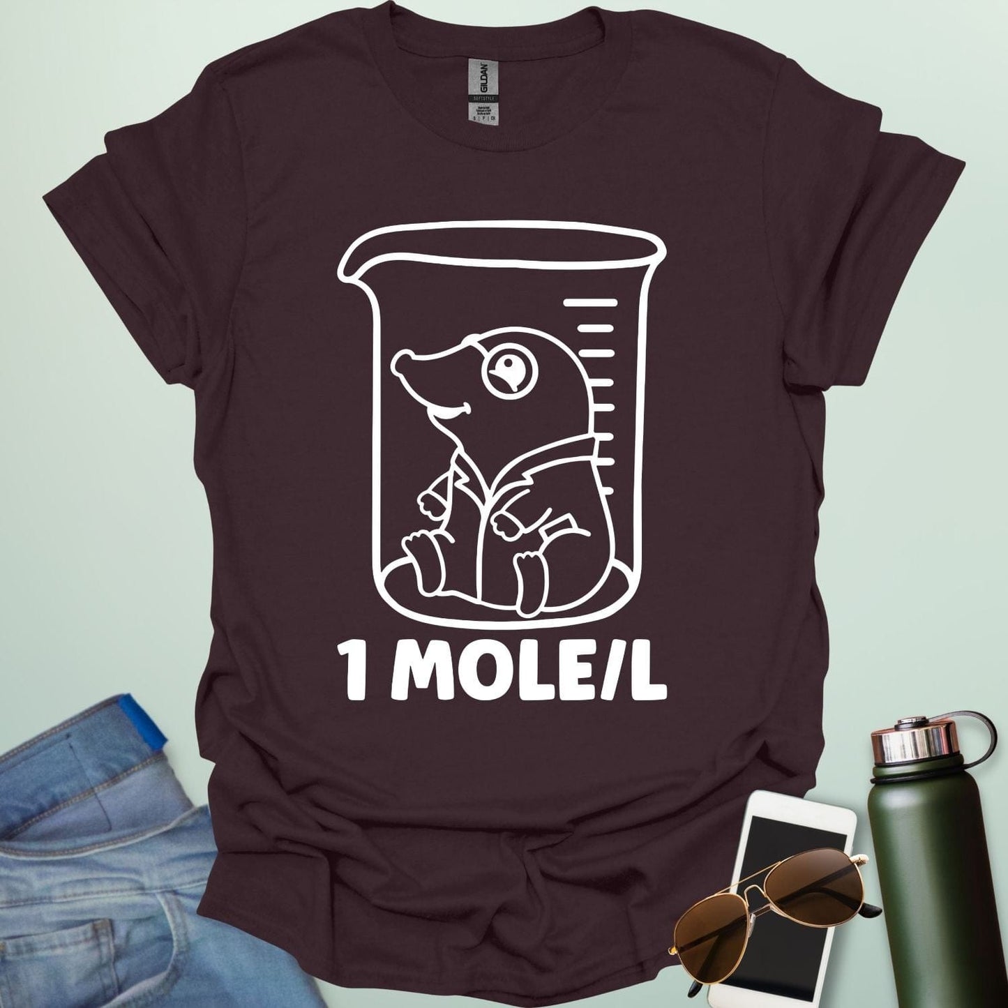 A funny chemistry t-shirt featuring a cartoon mole inside a science beaker. The design includes the text '1 MOLE/L,' a clever pun for chemists and science students.