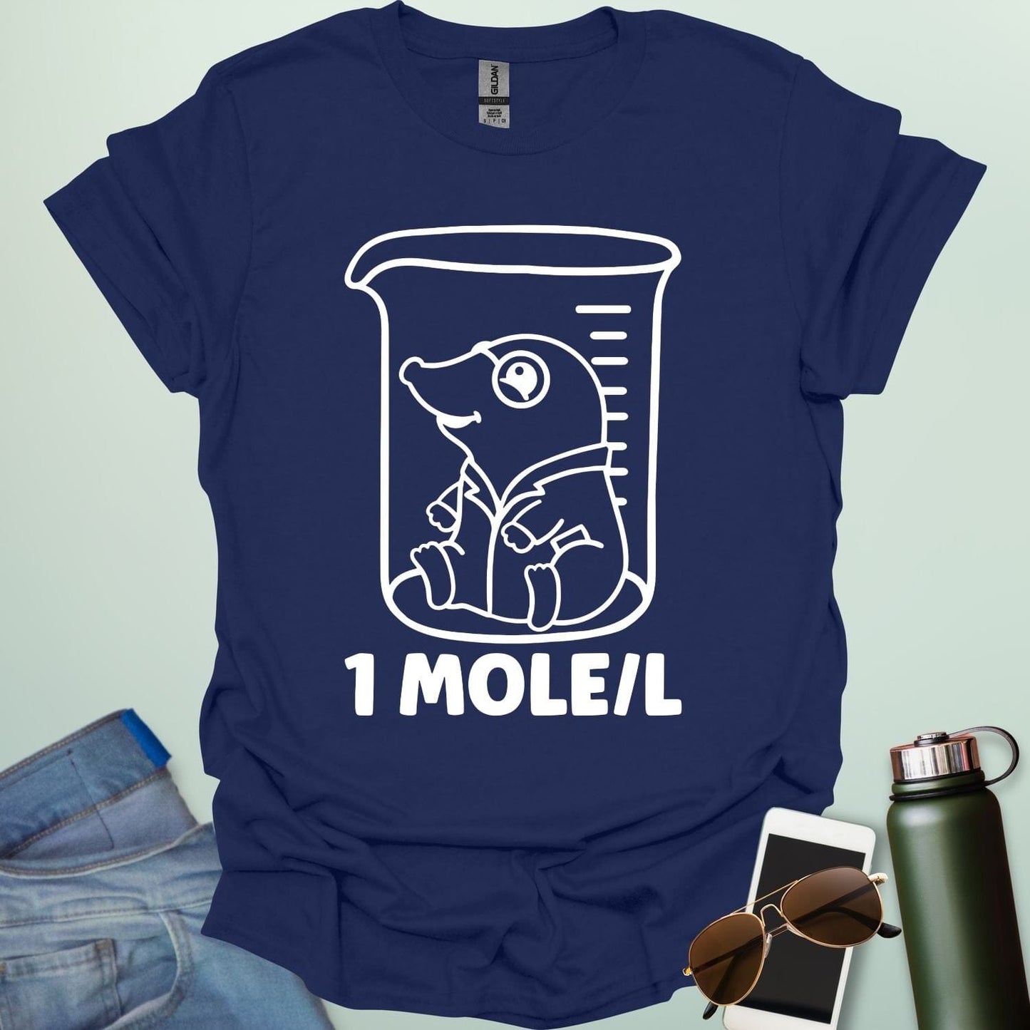 A funny chemistry t-shirt featuring a cartoon mole inside a science beaker. The design includes the text '1 MOLE/L,' a clever pun for chemists and science students.