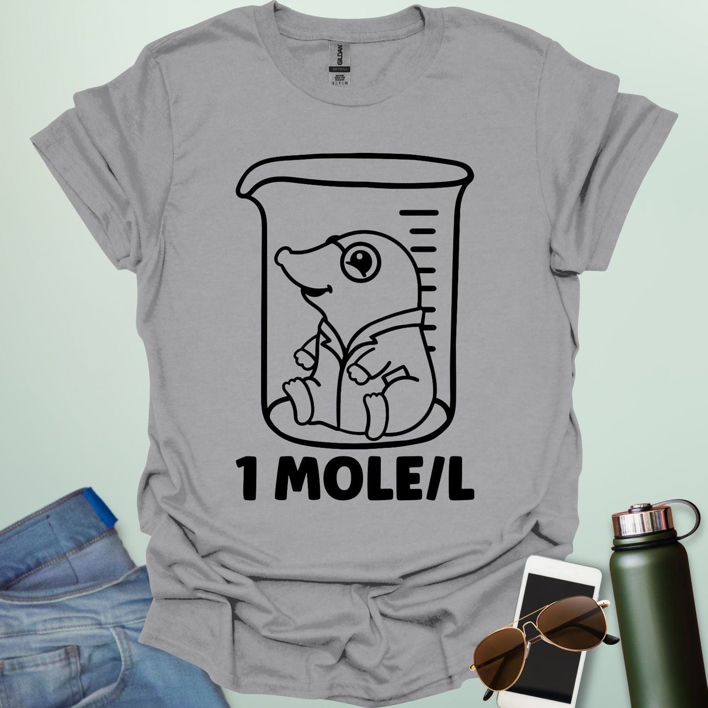 A funny chemistry t-shirt featuring a cartoon mole inside a science beaker. The design includes the text '1 MOLE/L,' a clever pun for chemists and science students.