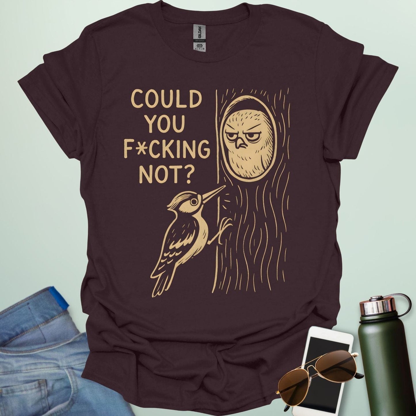 Minimal illustration of an irritated owl peeking from its tree burrow while a woodpecker pecks at the trunk, with bold text reading “COULD YOU F*CKING NOT?” on a dark background.