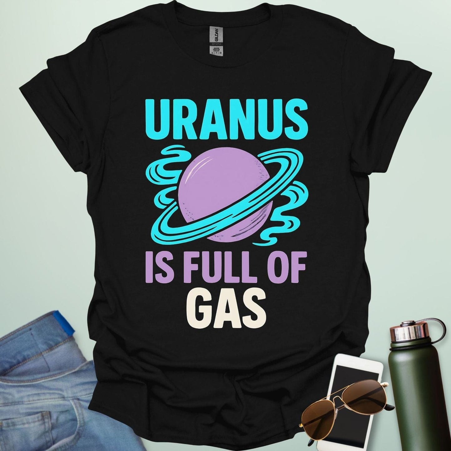 Graphic of the planet Uranus with fun typography reading “Uranus Is Full of Gas” — a humorous astronomy / space pun on a dark background.