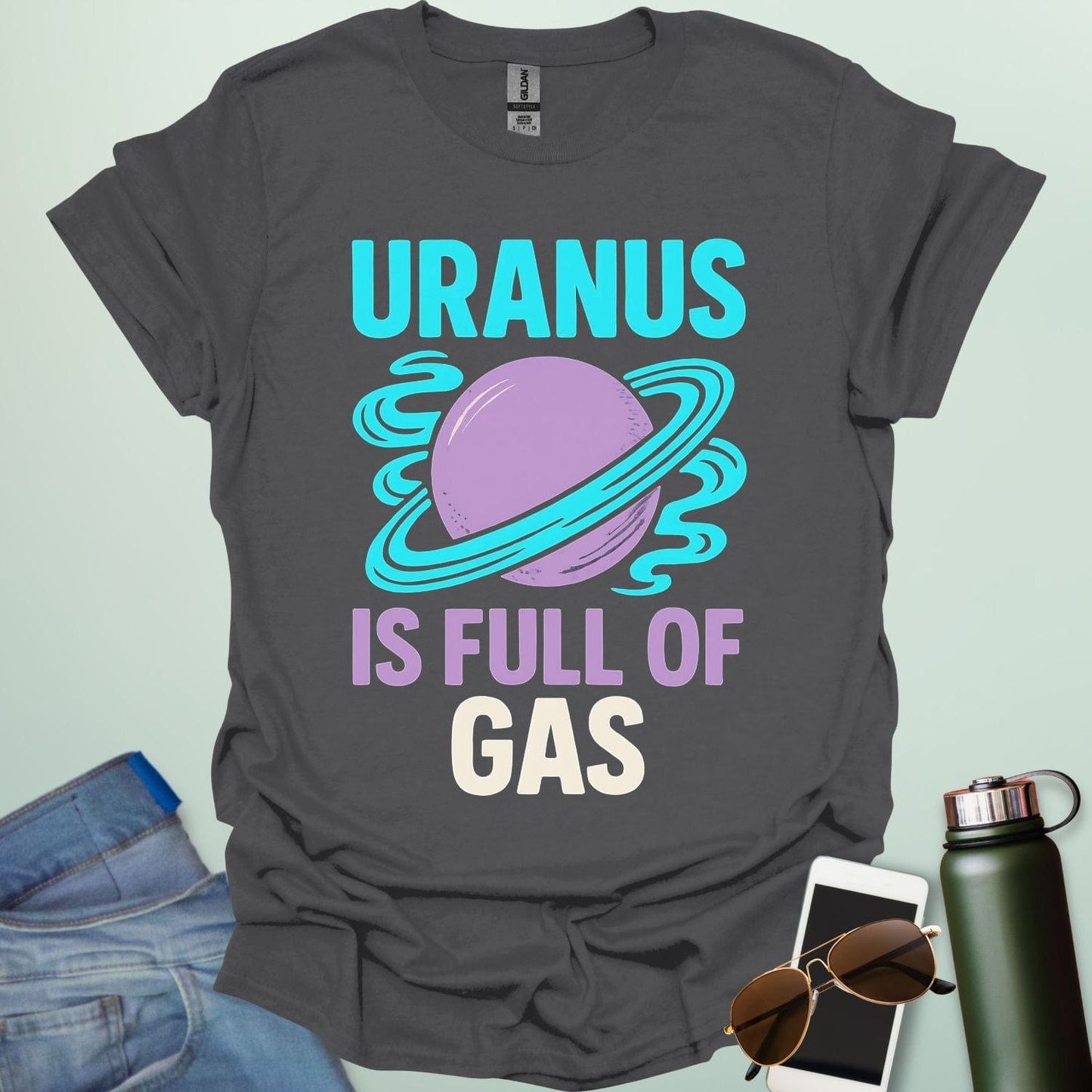 Graphic of the planet Uranus with fun typography reading “Uranus Is Full of Gas” — a humorous astronomy / space pun on a dark background.