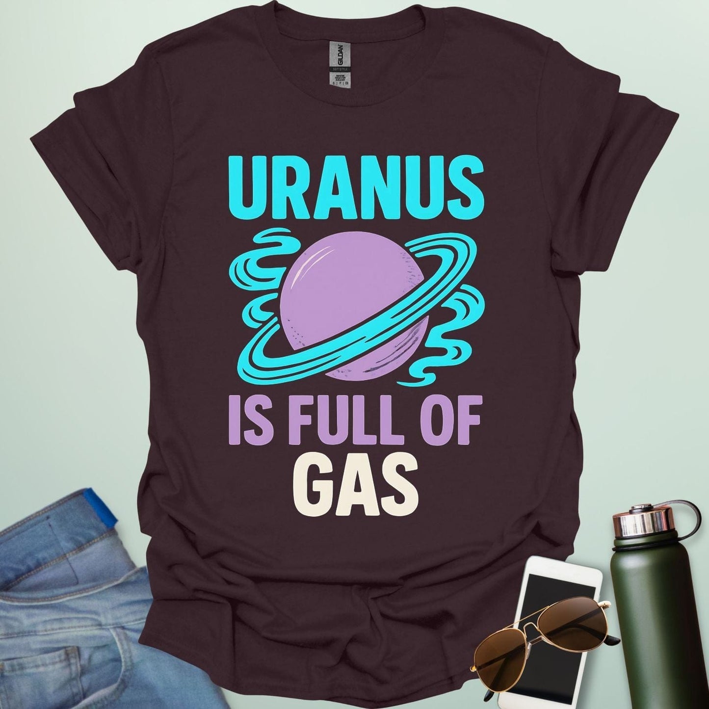 Graphic of the planet Uranus with fun typography reading “Uranus Is Full of Gas” — a humorous astronomy / space pun on a dark background.