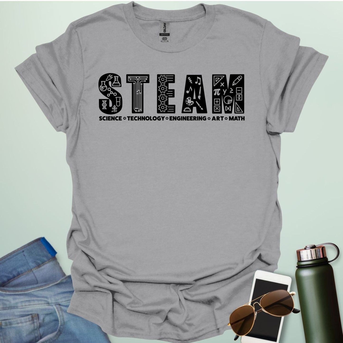 Sport gray tee with the word 'STEAM' with each letter filled with related icons, and the words 'SCIENCE TECHNOLOGY ENGINEERING ART MATH' below.
