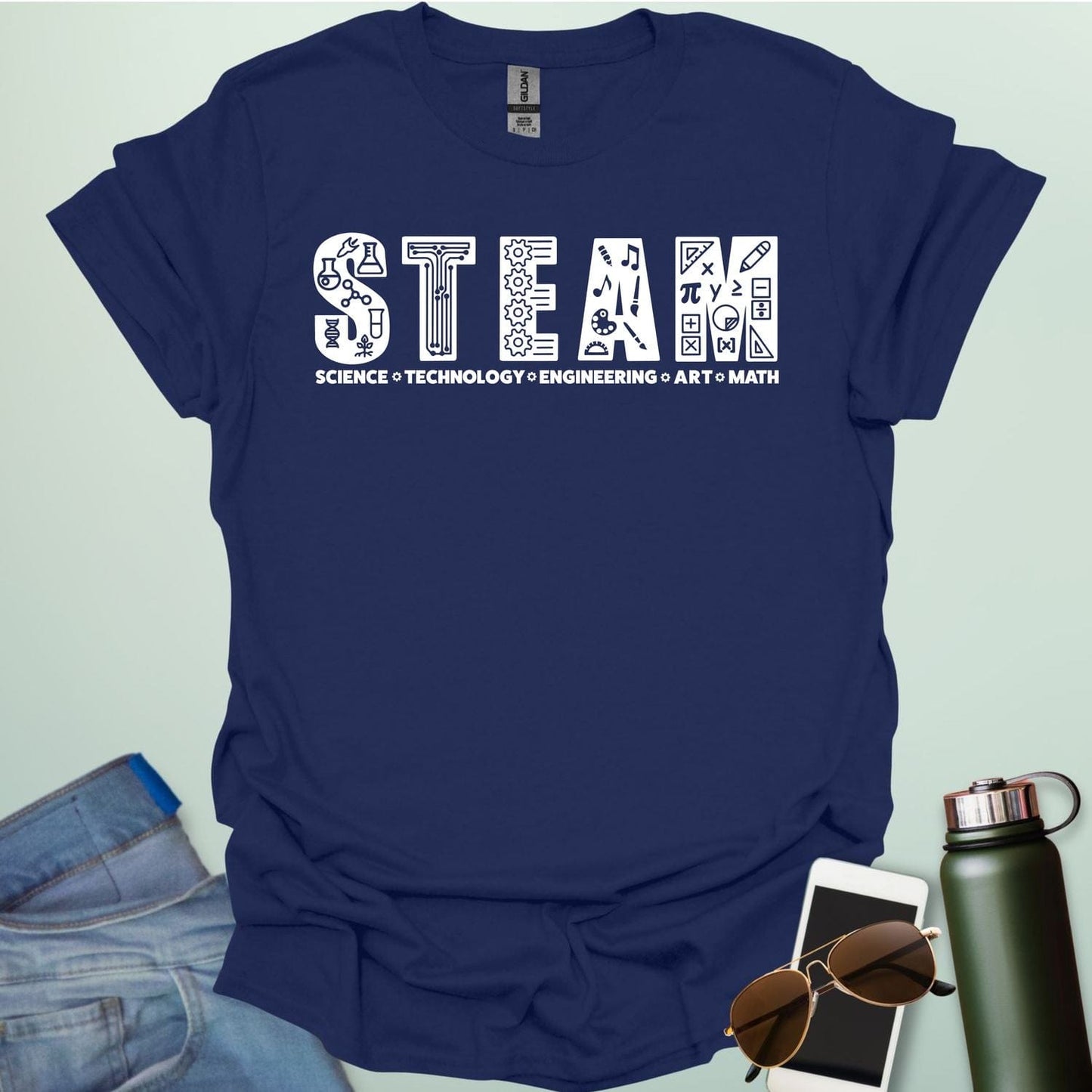 Navy blue tee with the word 'STEAM' with each letter filled with related icons, and the words 'SCIENCE TECHNOLOGY ENGINEERING ART MATH' below.