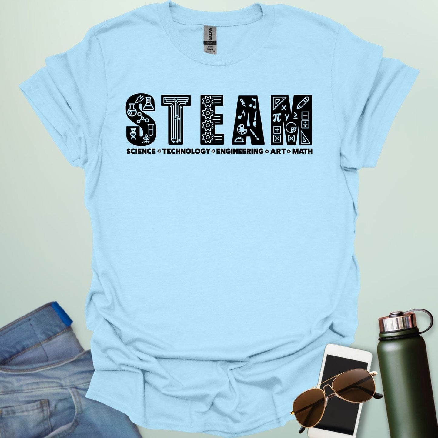 Light blue tee with the word 'STEAM' with each letter filled with related icons, and the words 'SCIENCE TECHNOLOGY ENGINEERING ART MATH' below.