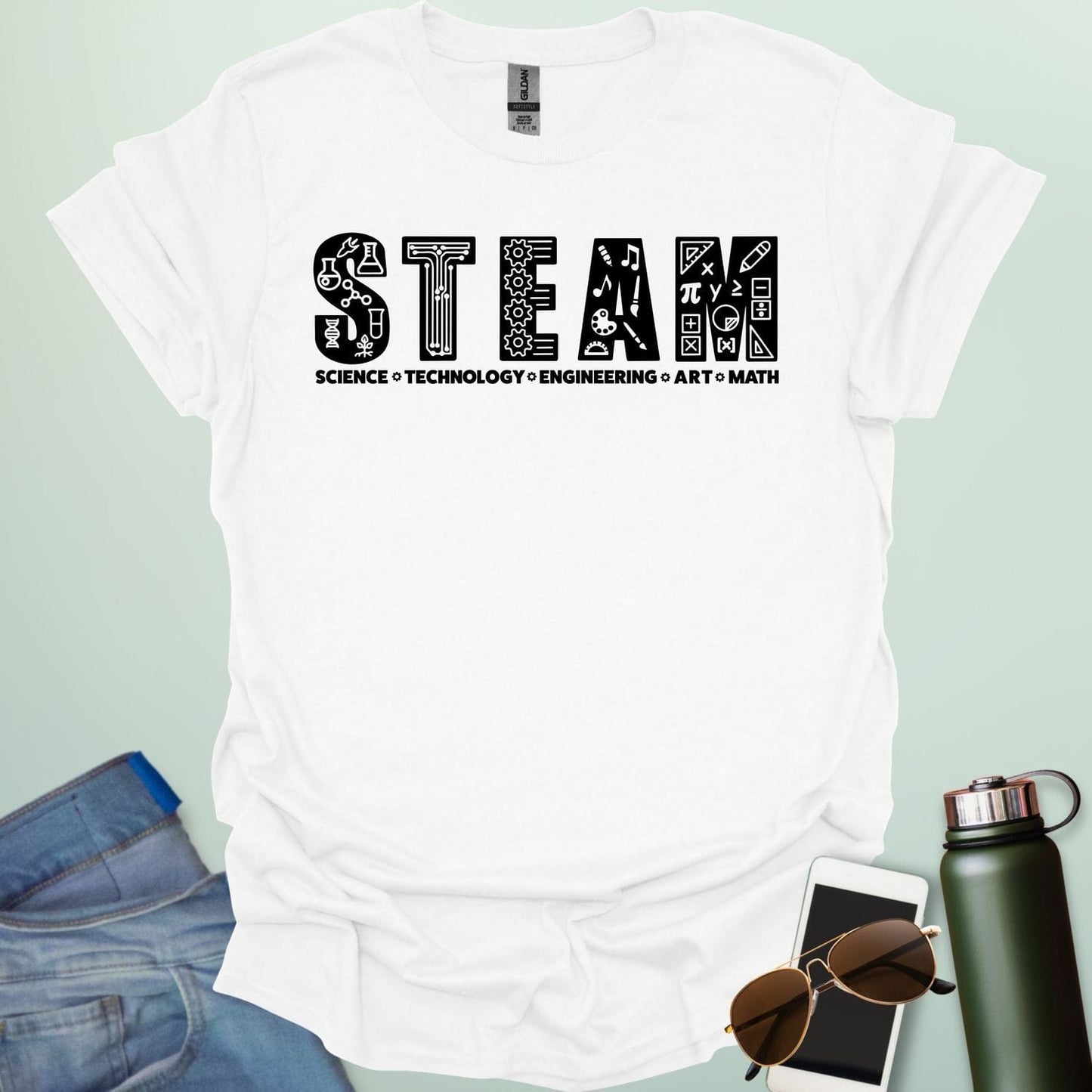 White tee with the word 'STEAM' with each letter filled with related icons, and the words 'SCIENCE TECHNOLOGY ENGINEERING ART MATH' below.