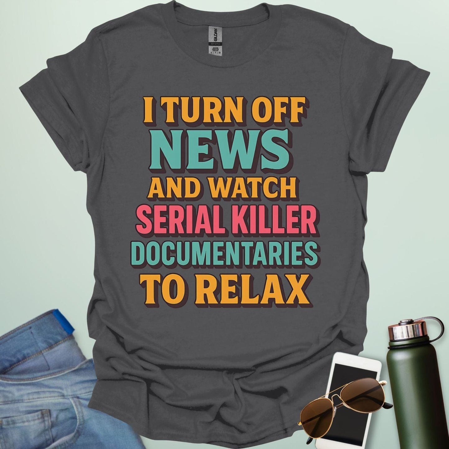 ‘I Turn Off News & Watch Serial Killer Documentaries To Relax’ t-shirt with bold typography — humorous true crime statement tee.
