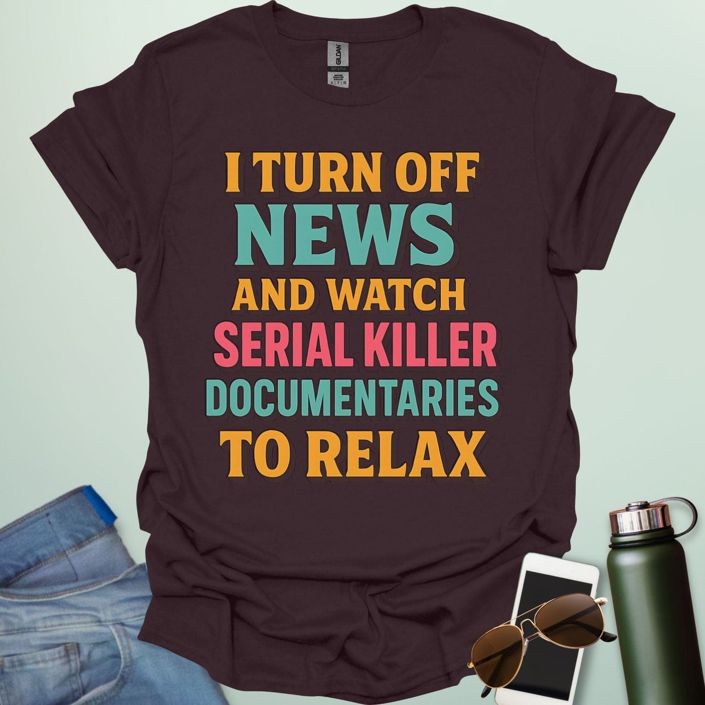 ‘I Turn Off News & Watch Serial Killer Documentaries To Relax’ t-shirt with bold typography — humorous true crime statement tee.