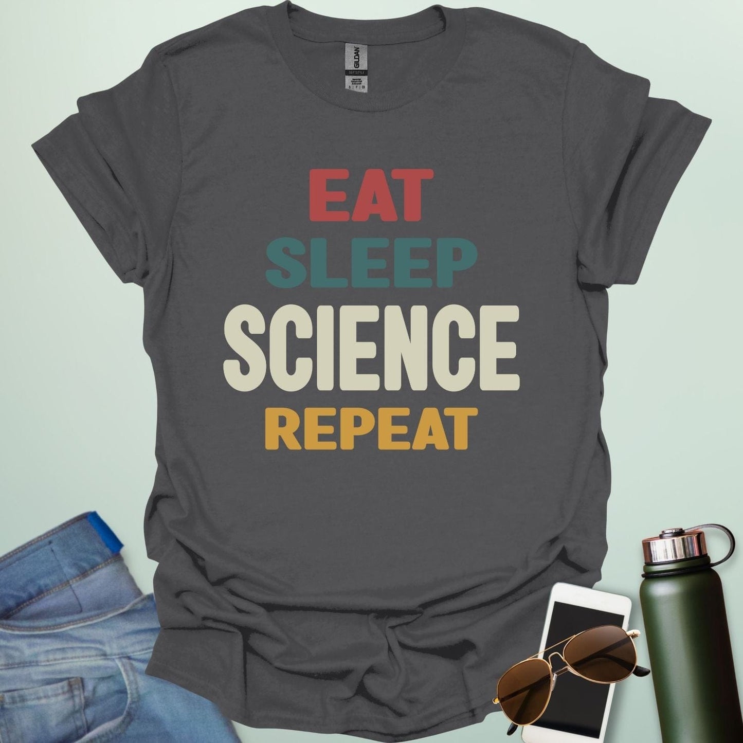 Eat Sleep Science Repeat t-shirt with bold text design — funny science lifestyle shirt for STEM students, teachers, and proud geeks.