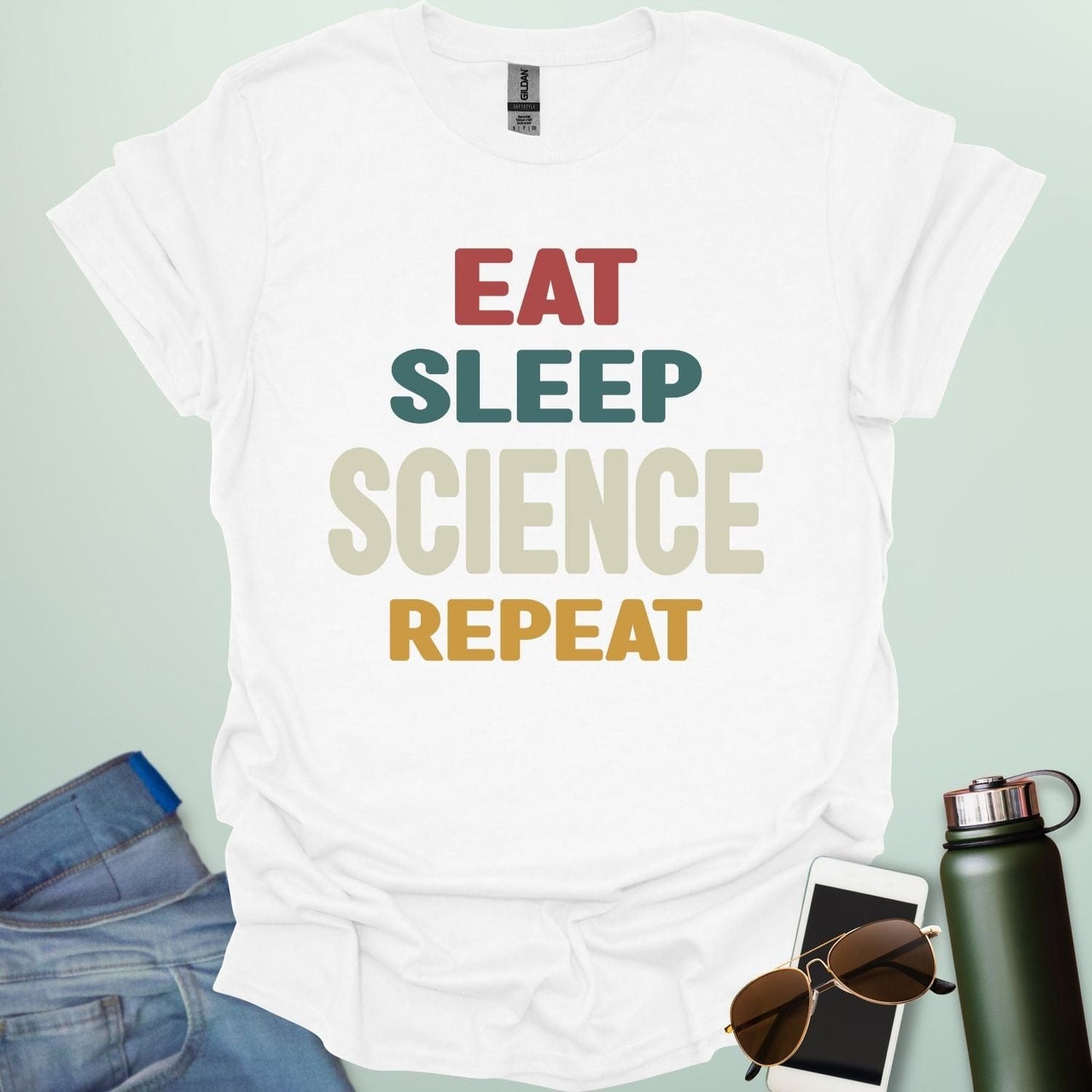 Eat Sleep Science Repeat t-shirt with bold text design — funny science lifestyle shirt for STEM students, teachers, and proud geeks.