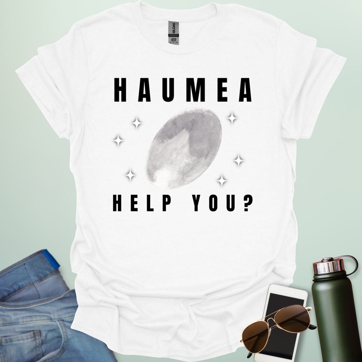 "A white t-shirt with a drawing of the dwarf planet Haumea and the text 'HAUMEA HELP YOU?'