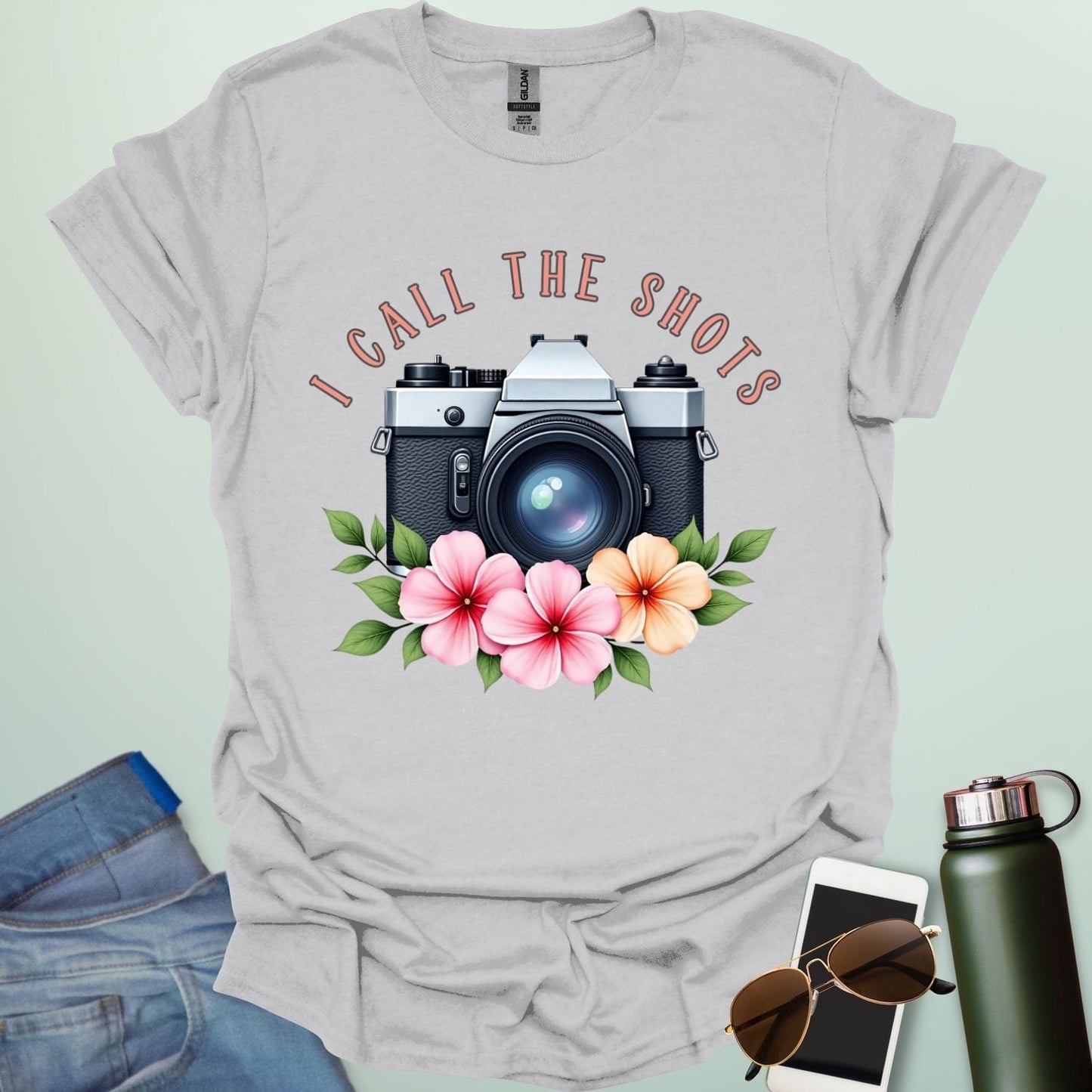 I Call the Shots t-shirt featuring a vintage camera graphic with floral accents β witty photographer humor tee for STEM and art lovers.