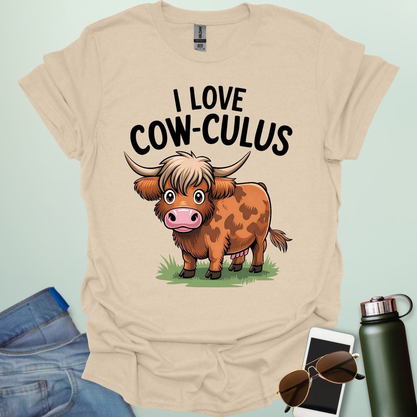 A cute and funny t-shirt featuring a highland cow in a field of flowers and the text 'I Love Cow-culus,' a perfect gift for math teachers and students.