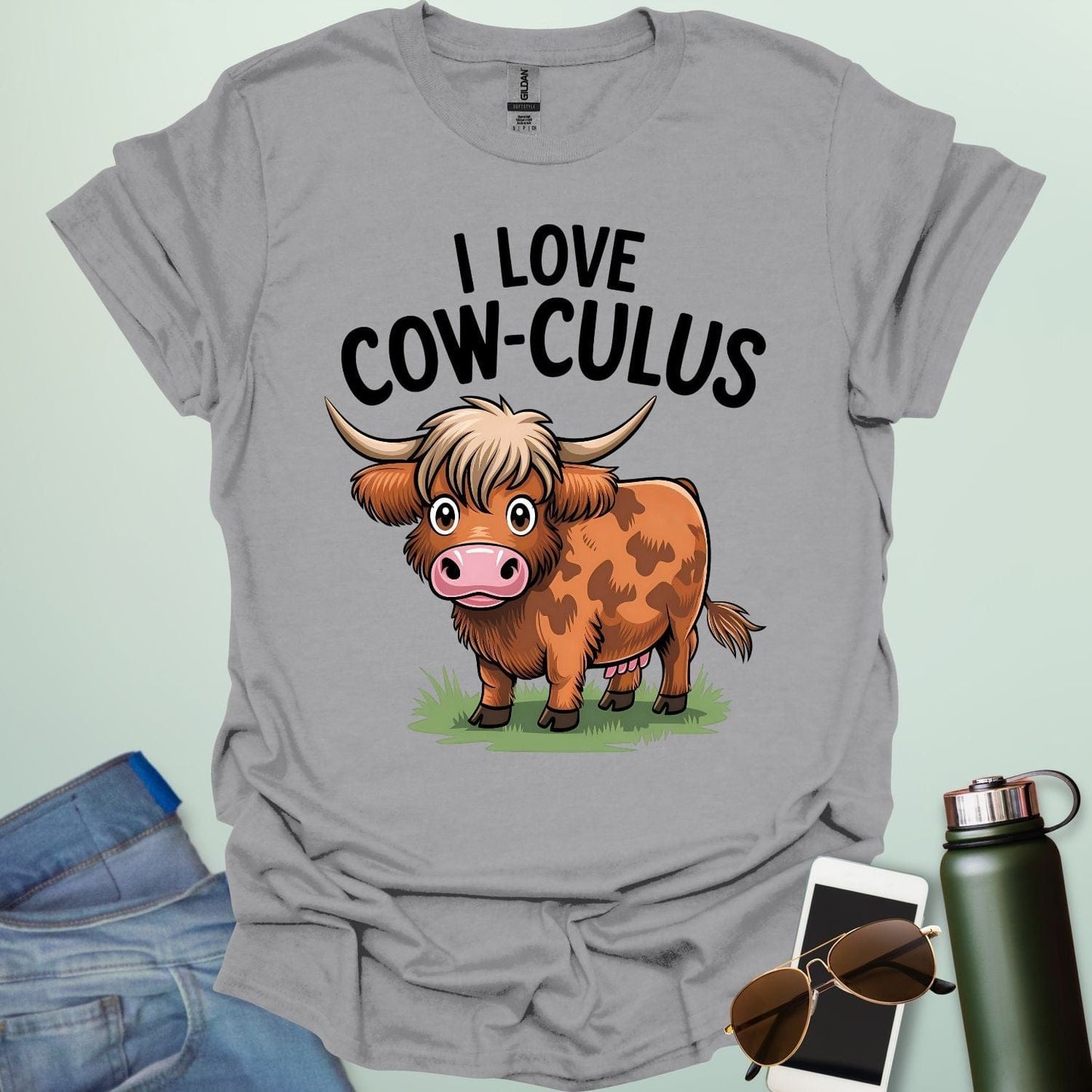 A cute and funny t-shirt featuring a highland cow in a field of flowers and the text 'I Love Cow-culus,' a perfect gift for math teachers and students.