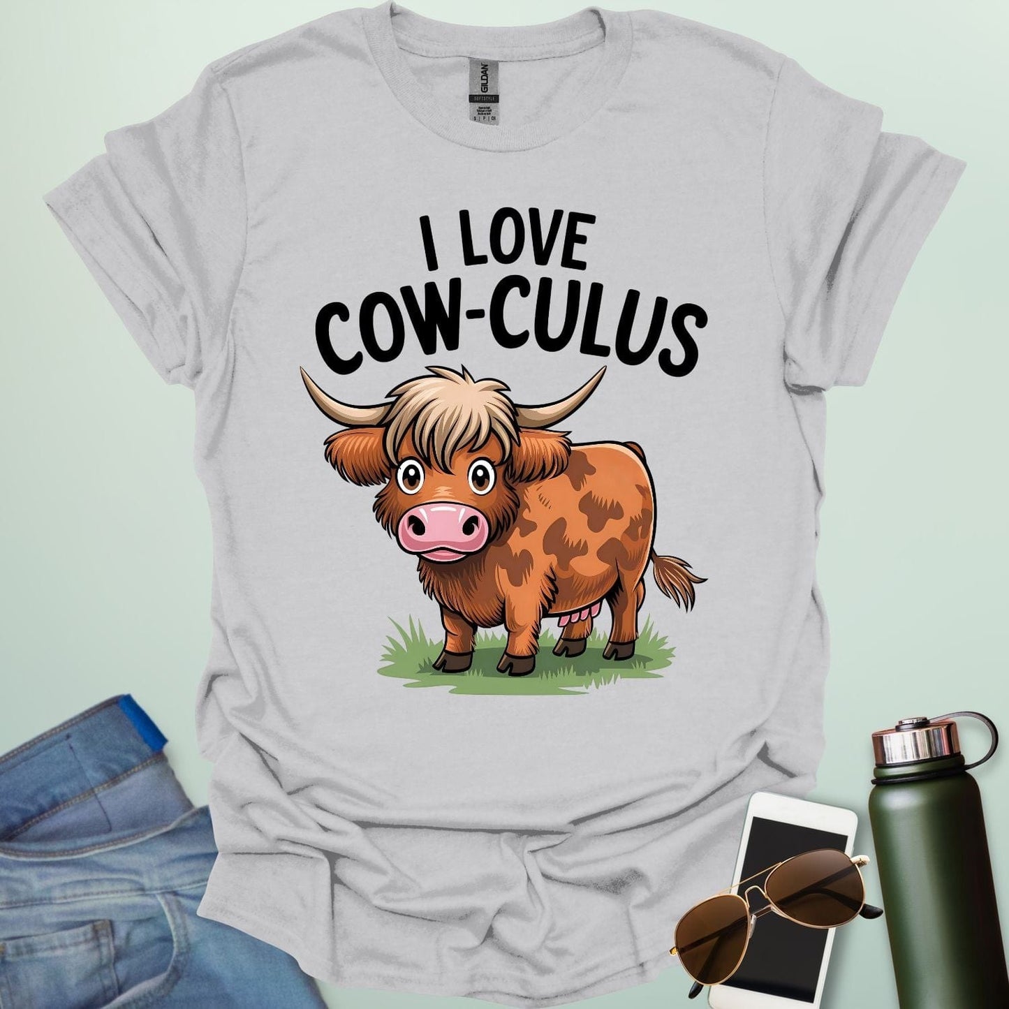 A cute and funny t-shirt featuring a highland cow in a field of flowers and the text 'I Love Cow-culus,' a perfect gift for math teachers and students.