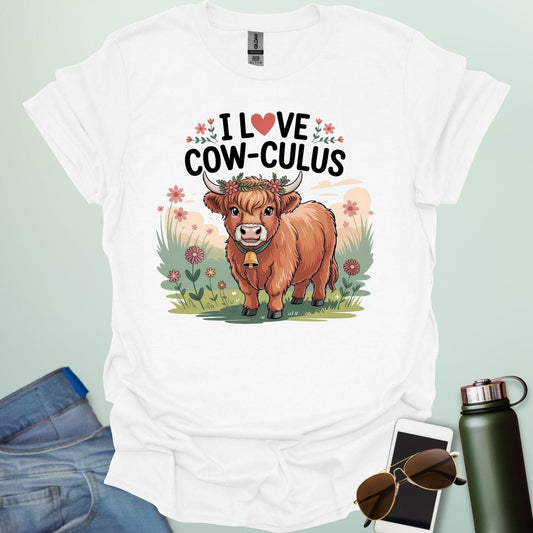 A white t-shirt with a cute illustration of a cow in a field and the text 'I love Cow-culus' with a heart symbol.