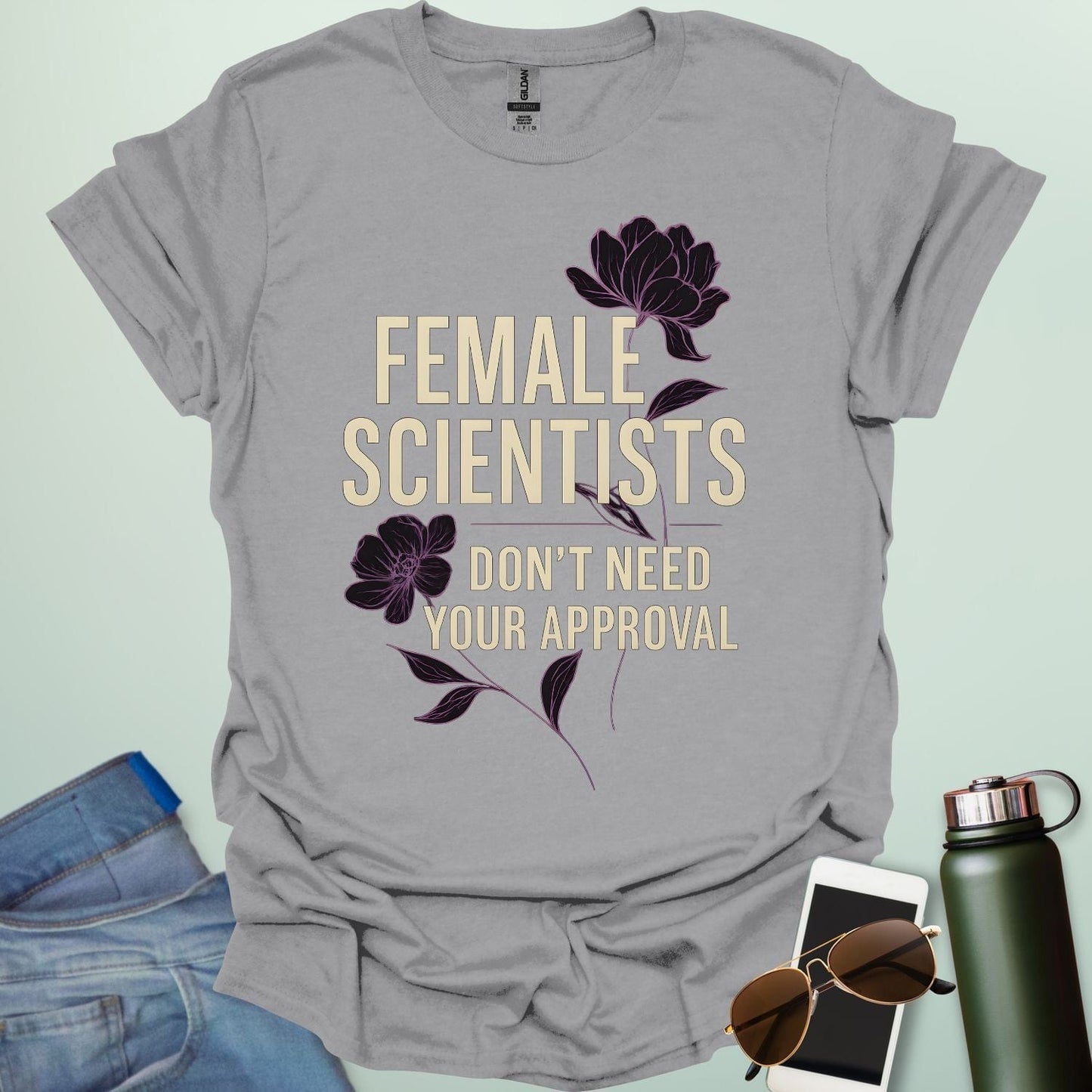 ‘Female Scientists Don’t Need Your Approval’ t-shirt with bold typography — feminist STEM apparel celebrating confident women in science.