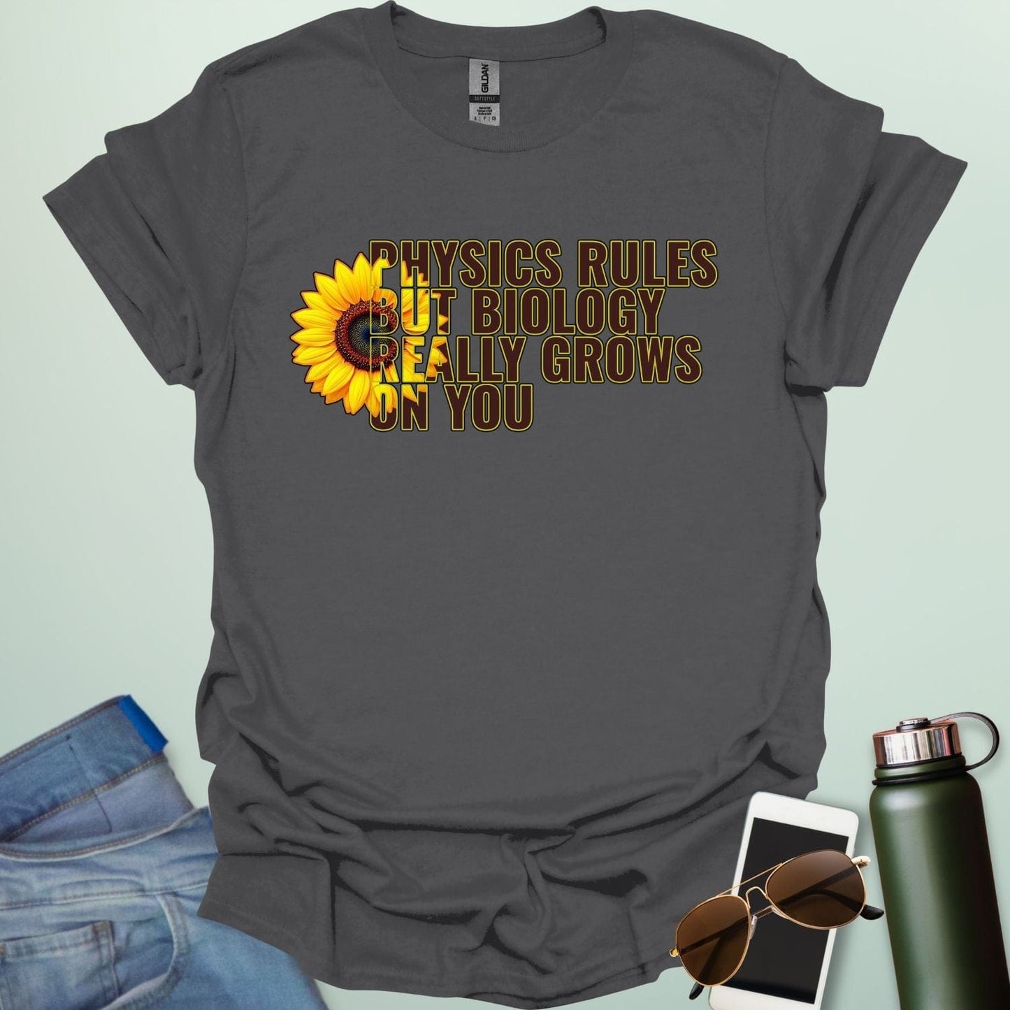 A funny biology t-shirt with a sunflower and the text 'Biology Really Grows On You,' a witty pun for biology teachers and plant lovers.