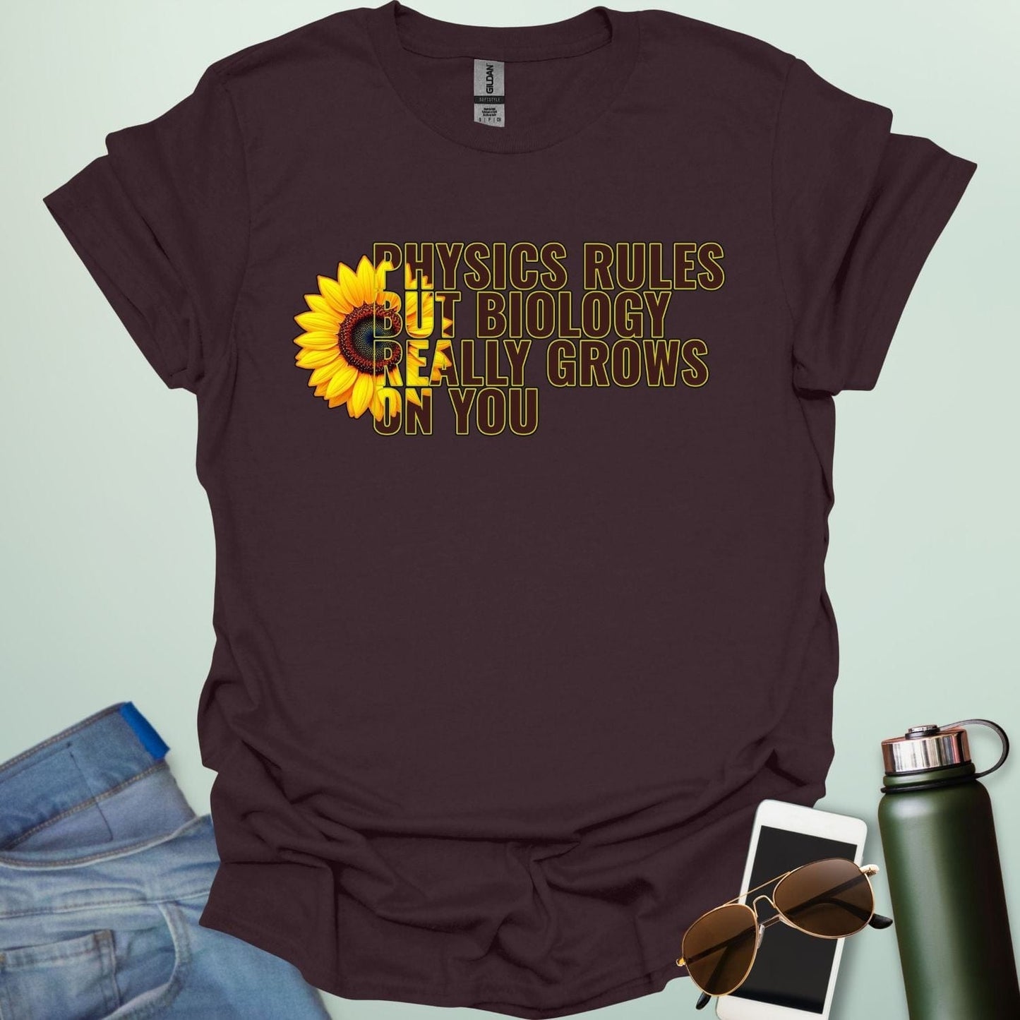 A funny biology t-shirt with a sunflower and the text 'Biology Really Grows On You,' a witty pun for biology teachers and plant lovers.