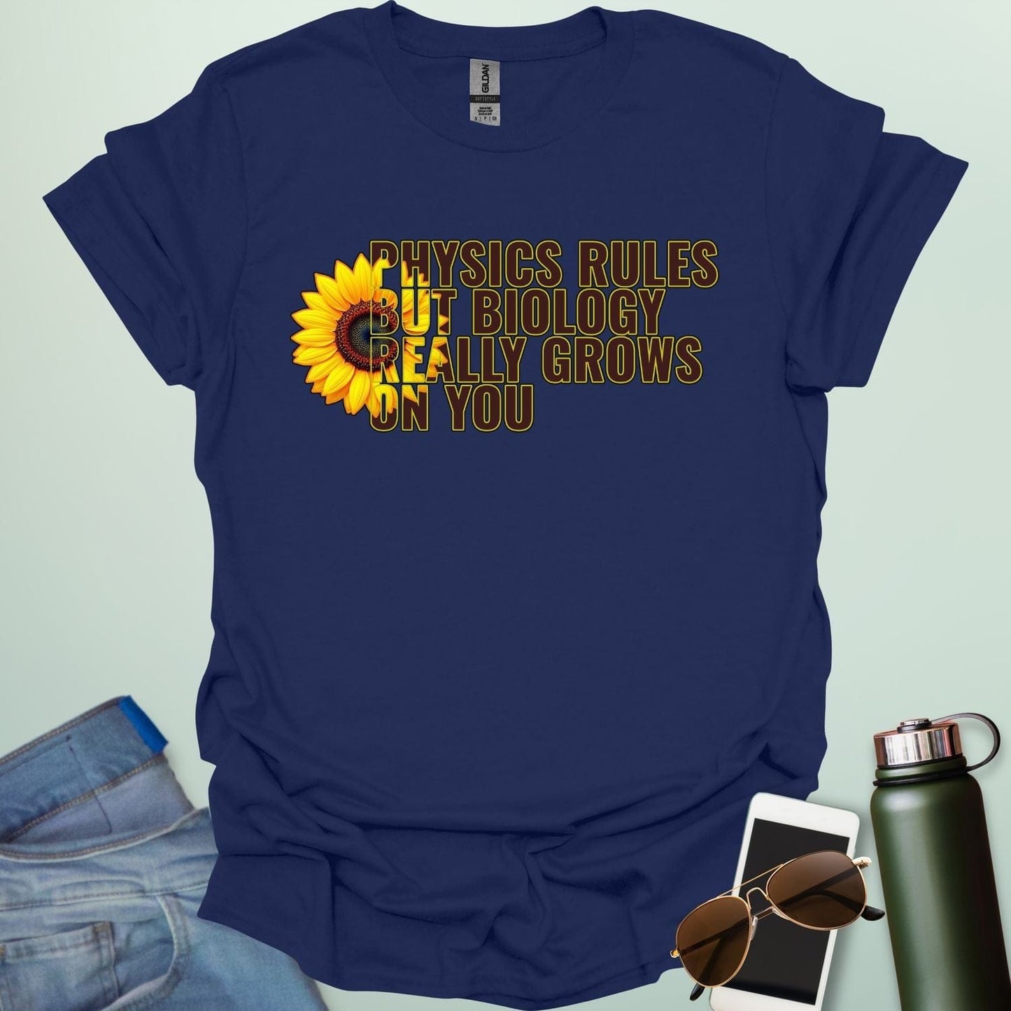 A funny biology t-shirt with a sunflower and the text 'Biology Really Grows On You,' a witty pun for biology teachers and plant lovers.