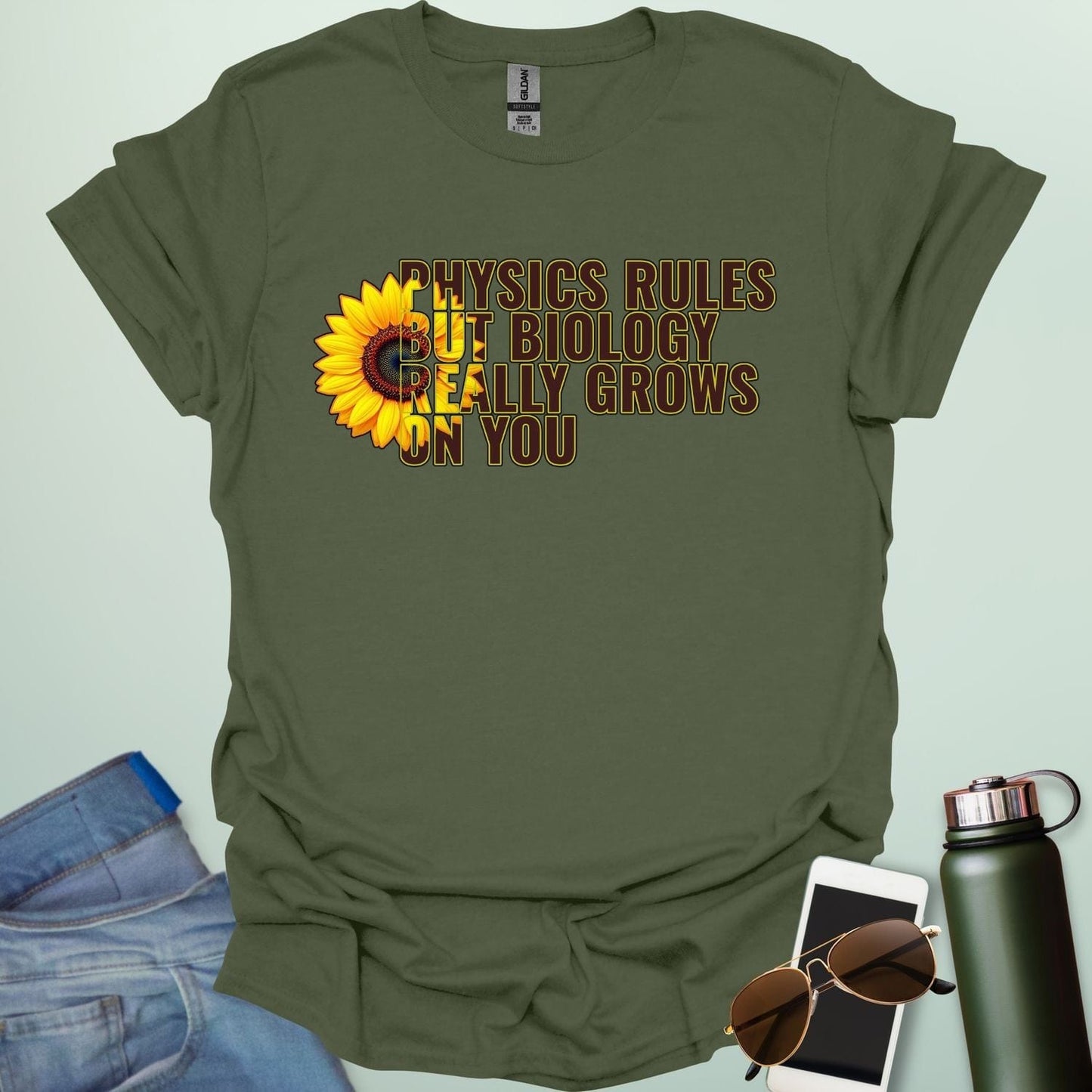 A funny biology t-shirt with a sunflower and the text 'Biology Really Grows On You,' a witty pun for biology teachers and plant lovers.