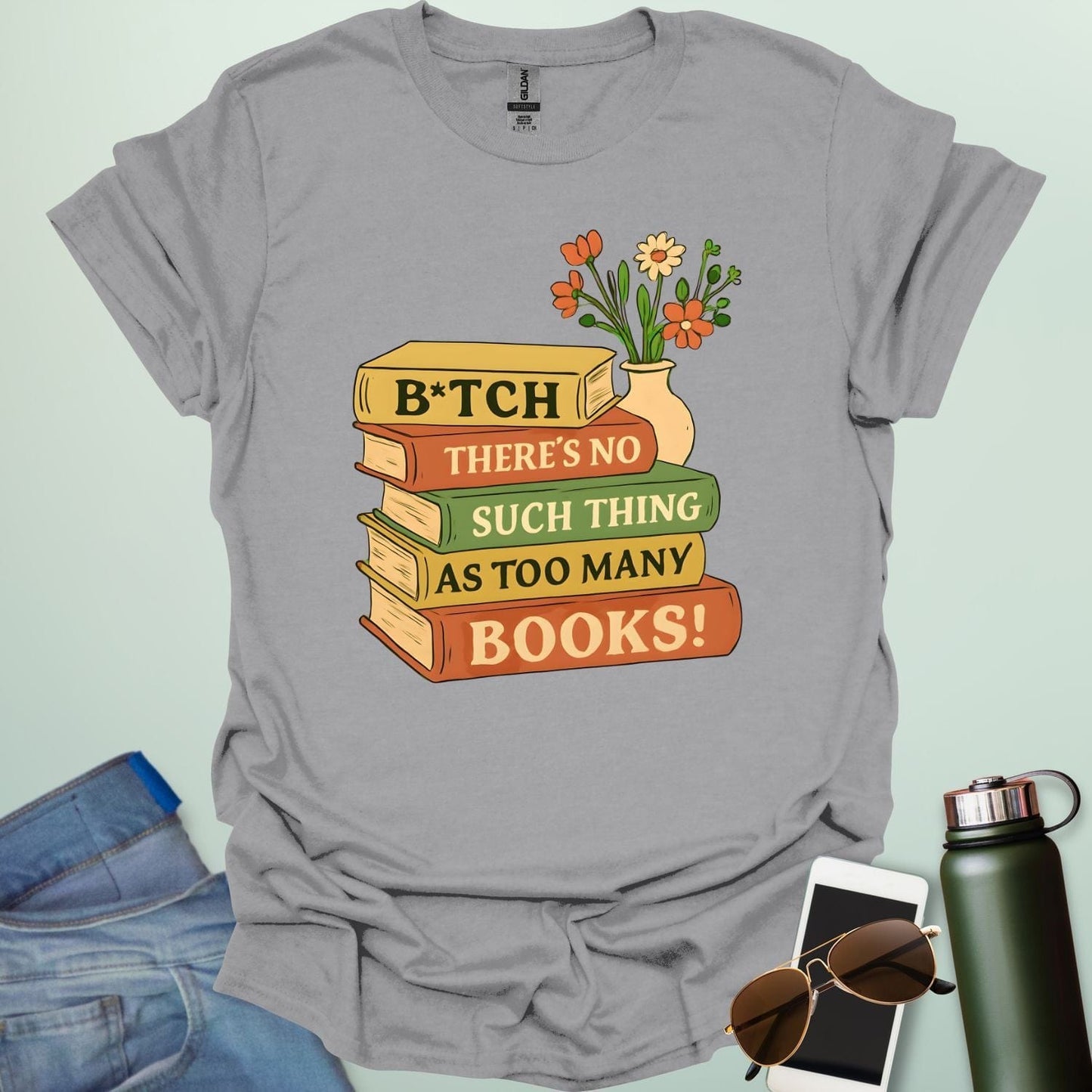 For readers with attitude — this bold “B*tch, There’s No Such Thing As Too Many Books” tee celebrates your love of literature with unapologetic wit.