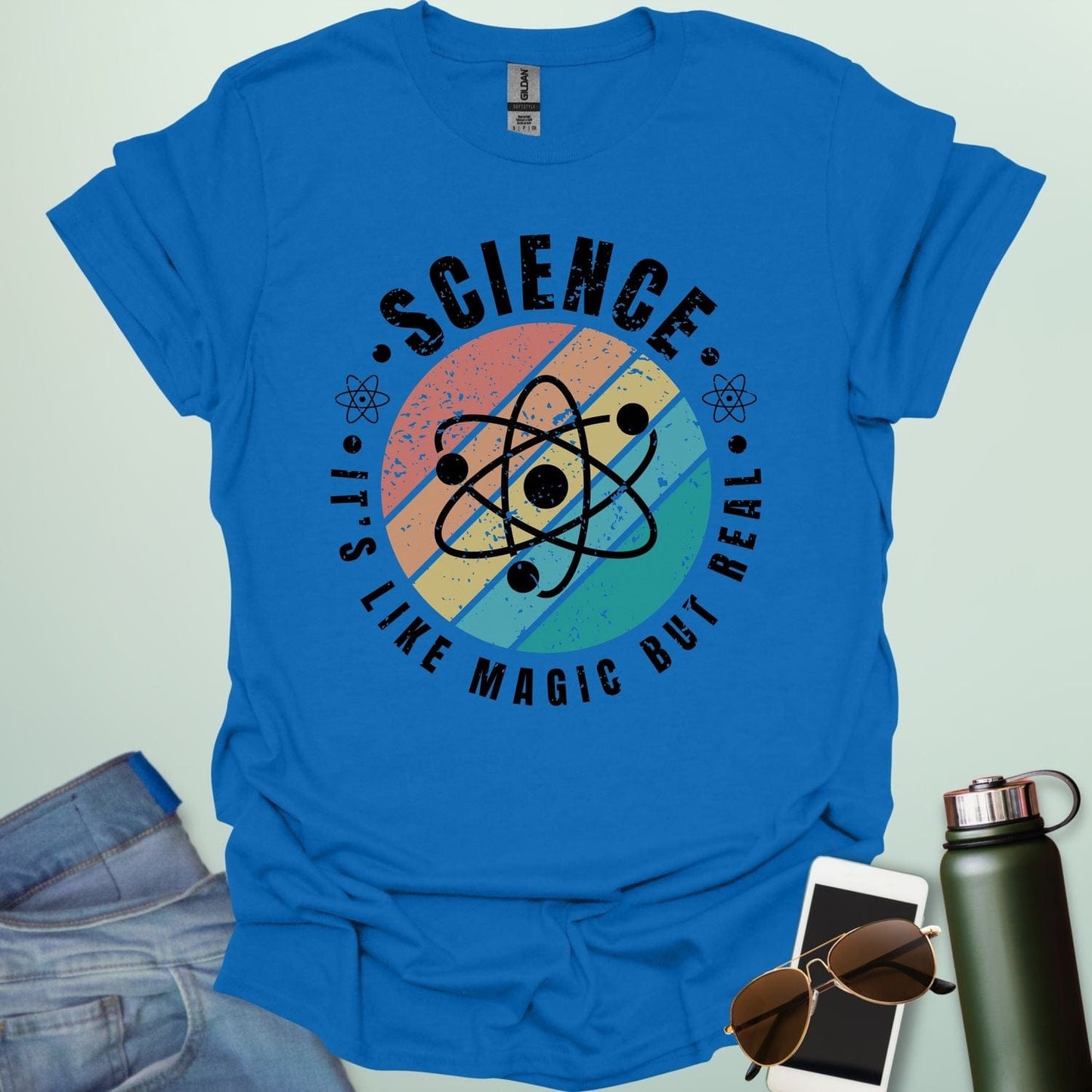 T-shirt with a clean design featuring an atom symbol and the quote 'Science - It's like magic but real'.