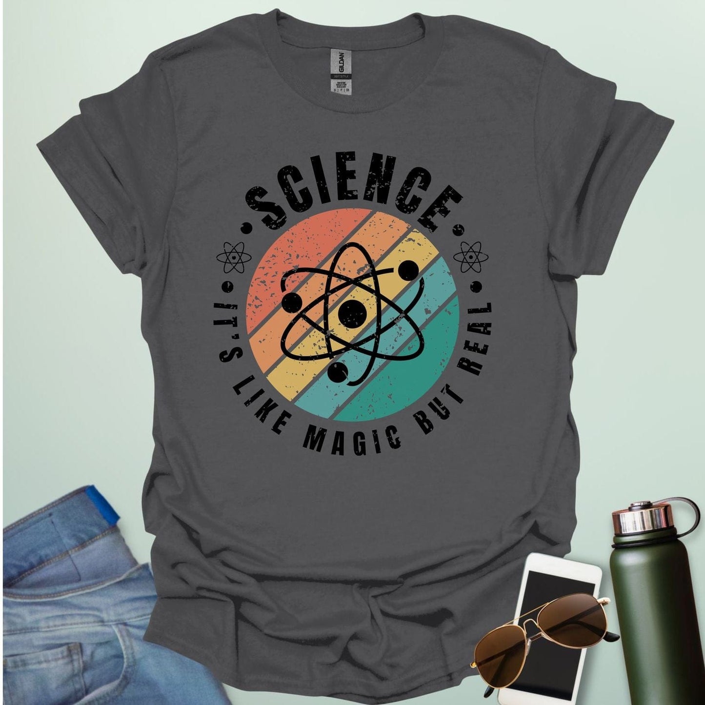 T-shirt with a clean design featuring an atom symbol and the quote 'Science - It's like magic but real'.