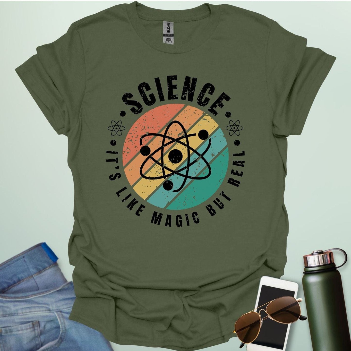 T-shirt with a clean design featuring an atom symbol and the quote 'Science - It's like magic but real'.