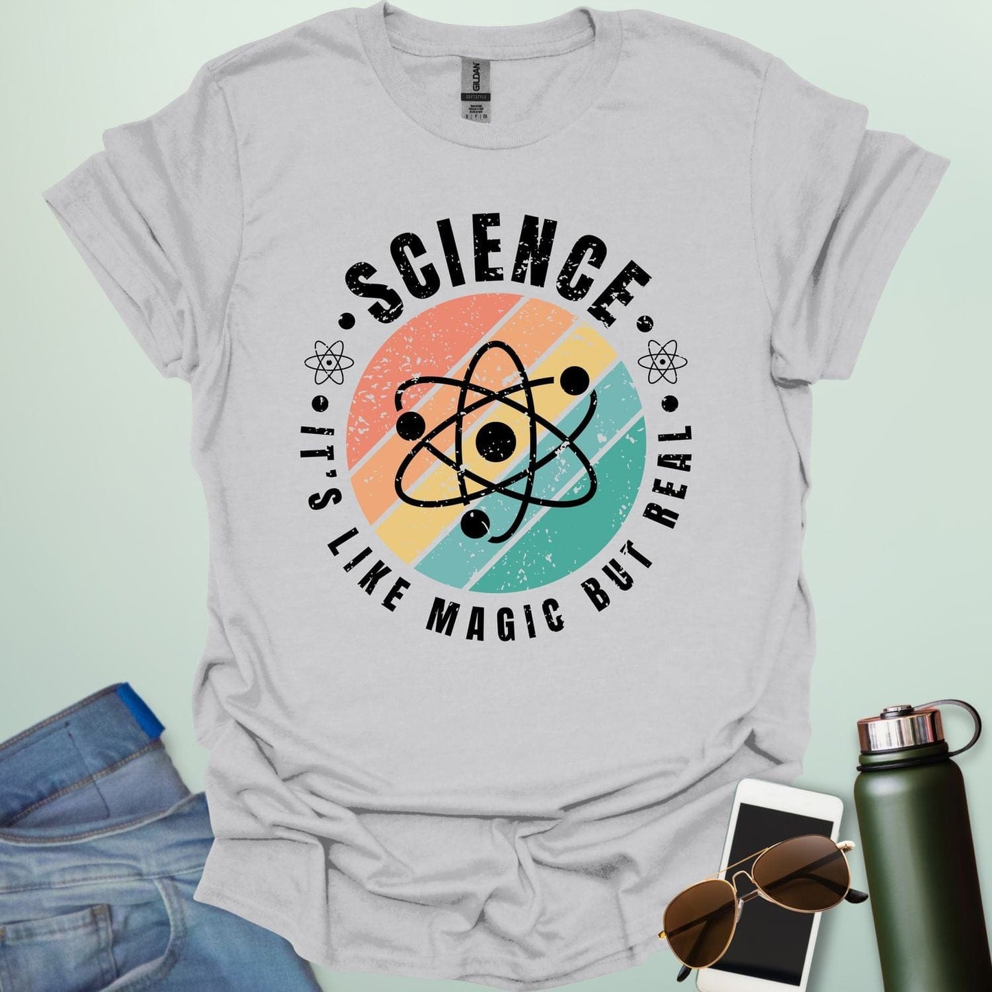 T-shirt with a clean design featuring an atom symbol and the quote 'Science - It's like magic but real'.