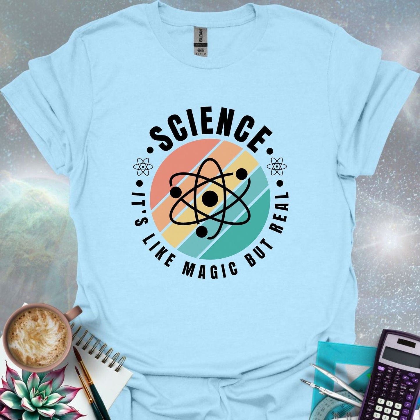 T-shirt with a clean design featuring an atom symbol and the quote 'Science - It's like magic but real'.