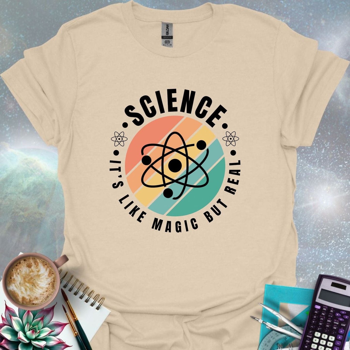 T-shirt with a clean design featuring an atom symbol and the quote 'Science - It's like magic but real'.