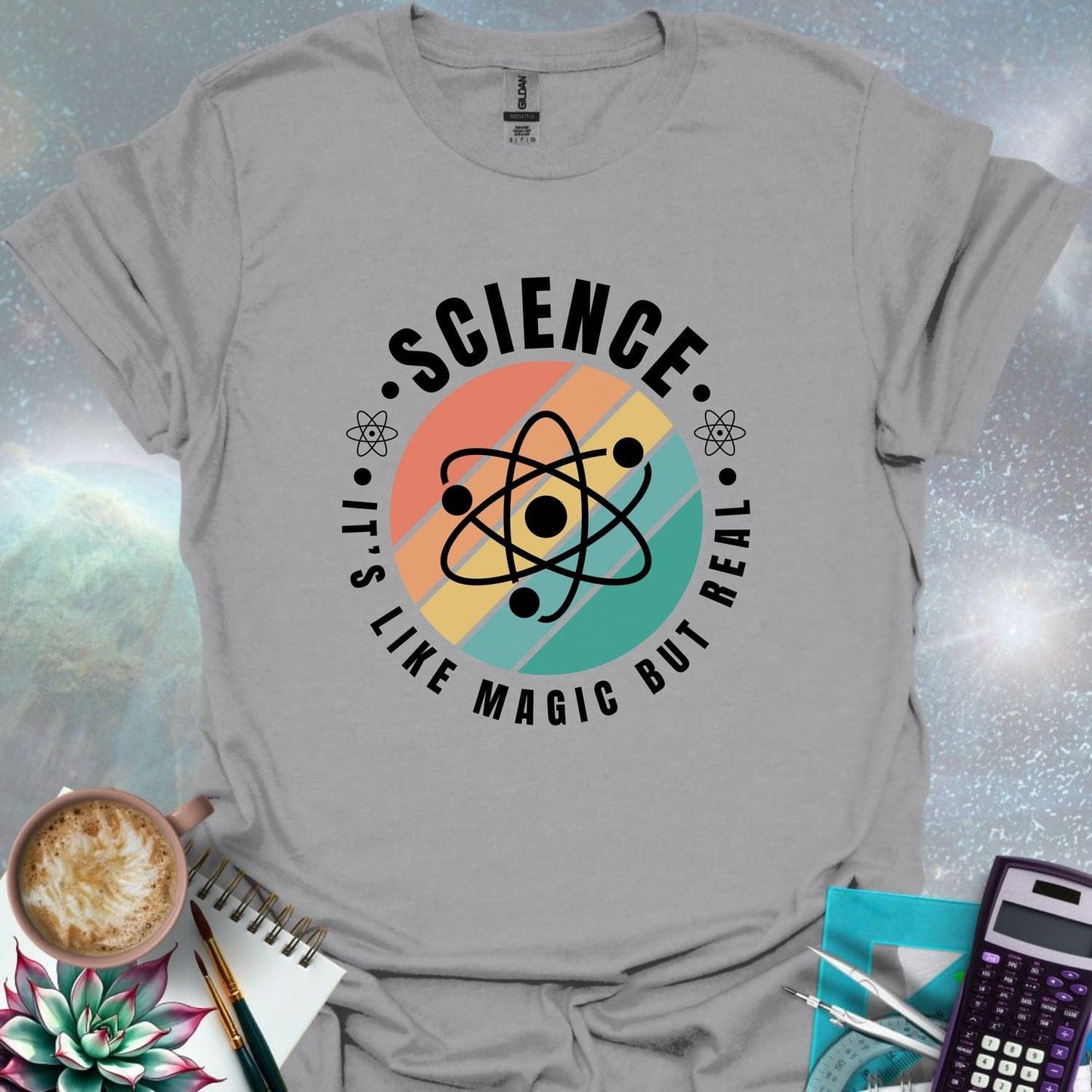 T-shirt with a clean design featuring an atom symbol and the quote 'Science - It's like magic but real'.