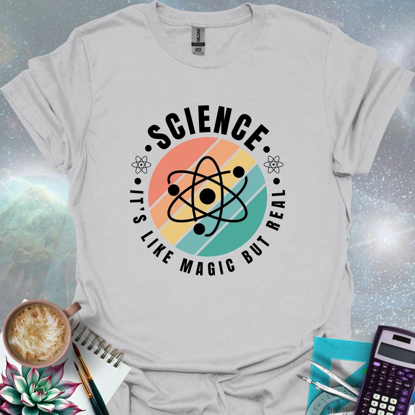 T-shirt with a clean design featuring an atom symbol and the quote 'Science - It's like magic but real'.